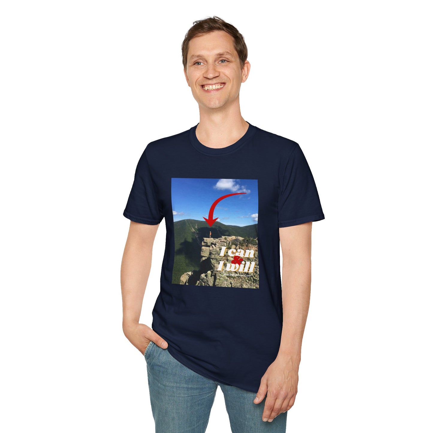 A smiling person in a blue hiking-themed unisex t-shirt, standing confidently on a rock. Made of soft, durable 100% cotton with a clean crew neckline. Ethically sourced and Oeko-Tex certified.