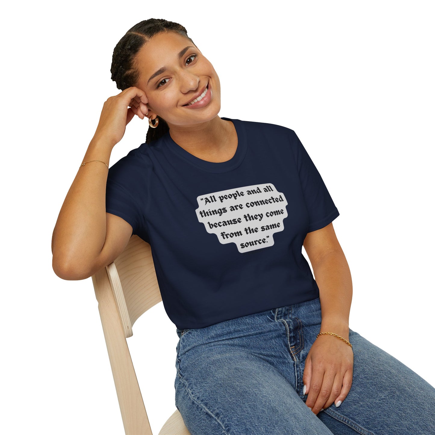 A woman in a blue shirt smiles, sitting on a chair, showcasing the All People are Connected Gray Unisex T-shirt. The image emphasizes casual fashion with a focus on the tee's quality and comfort.