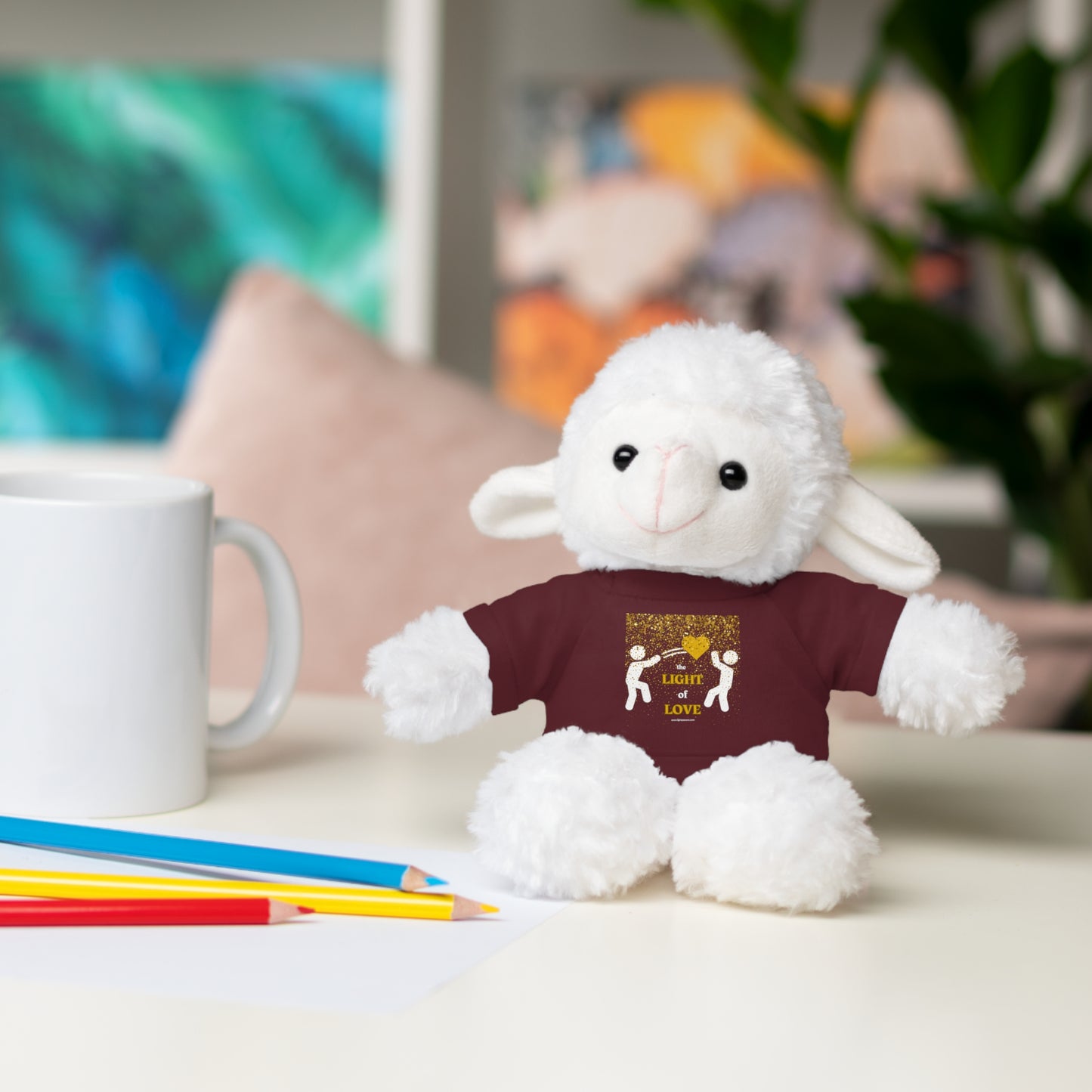 Cool Stuff Stuffies Light of Love Gold Heart features a stuffed animal on a table, wearing a customizable tee, ideal for children ages 3+.