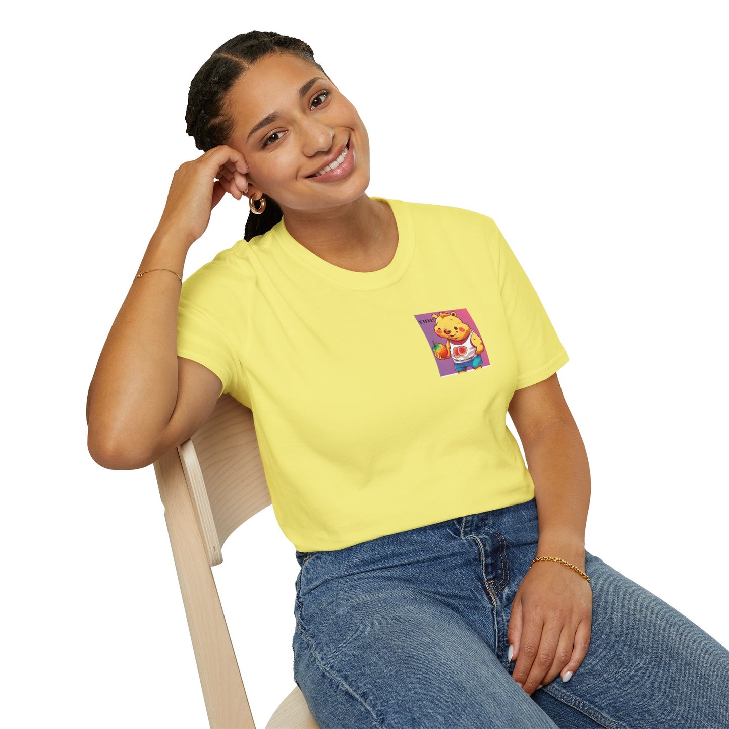 A woman in a yellow shirt sits on a chair, smiling. A cartoon bear holds a fruit nearby. Yum Strawberries Unisex T-Shirt: soft, 100% cotton tee with twill tape shoulders, no side seams, and ribbed collar.