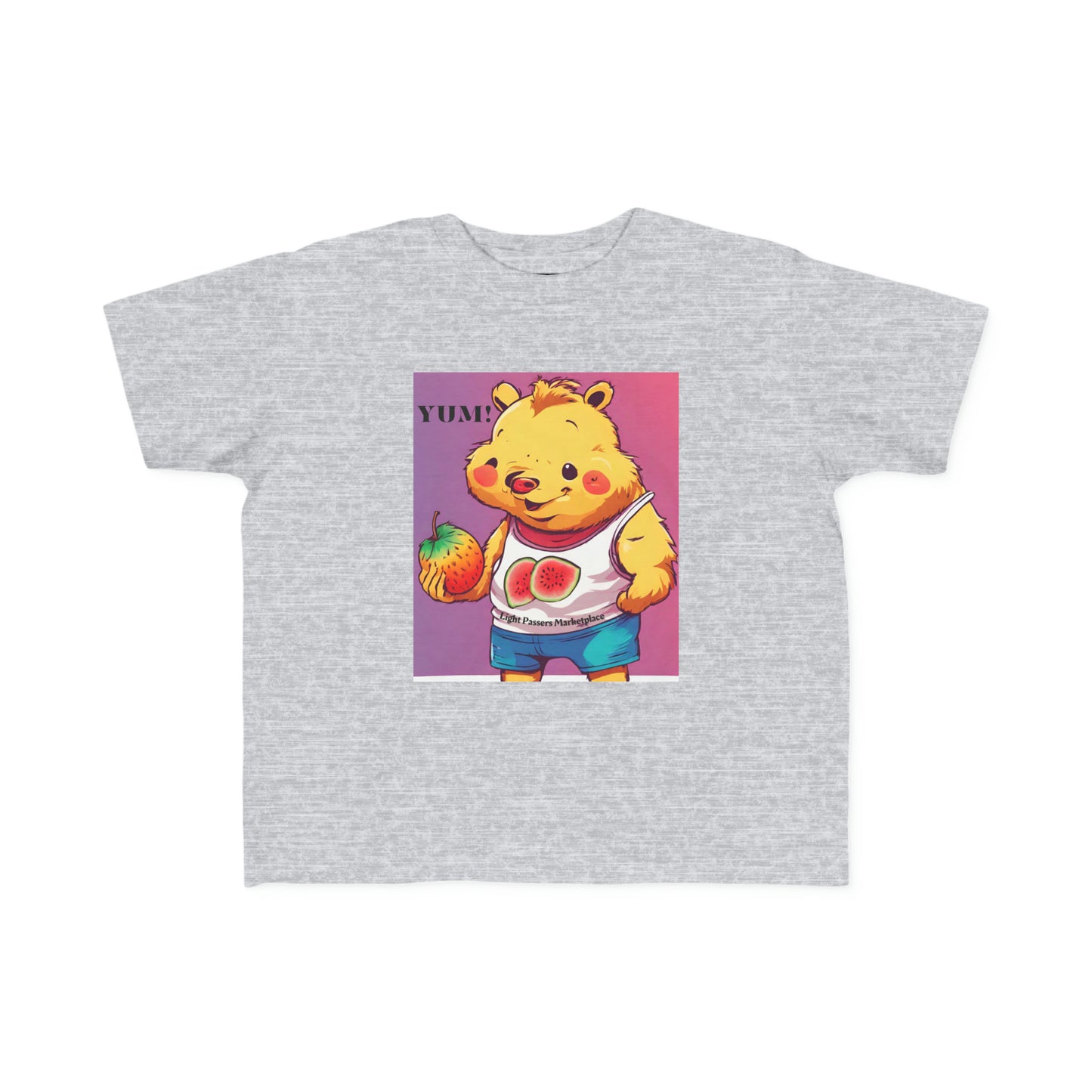 A toddler t-shirt featuring a cartoon bear holding a fruit, embodying softness for sensitive skin. Made of 100% combed cotton, light fabric, classic fit, and tear-away label.