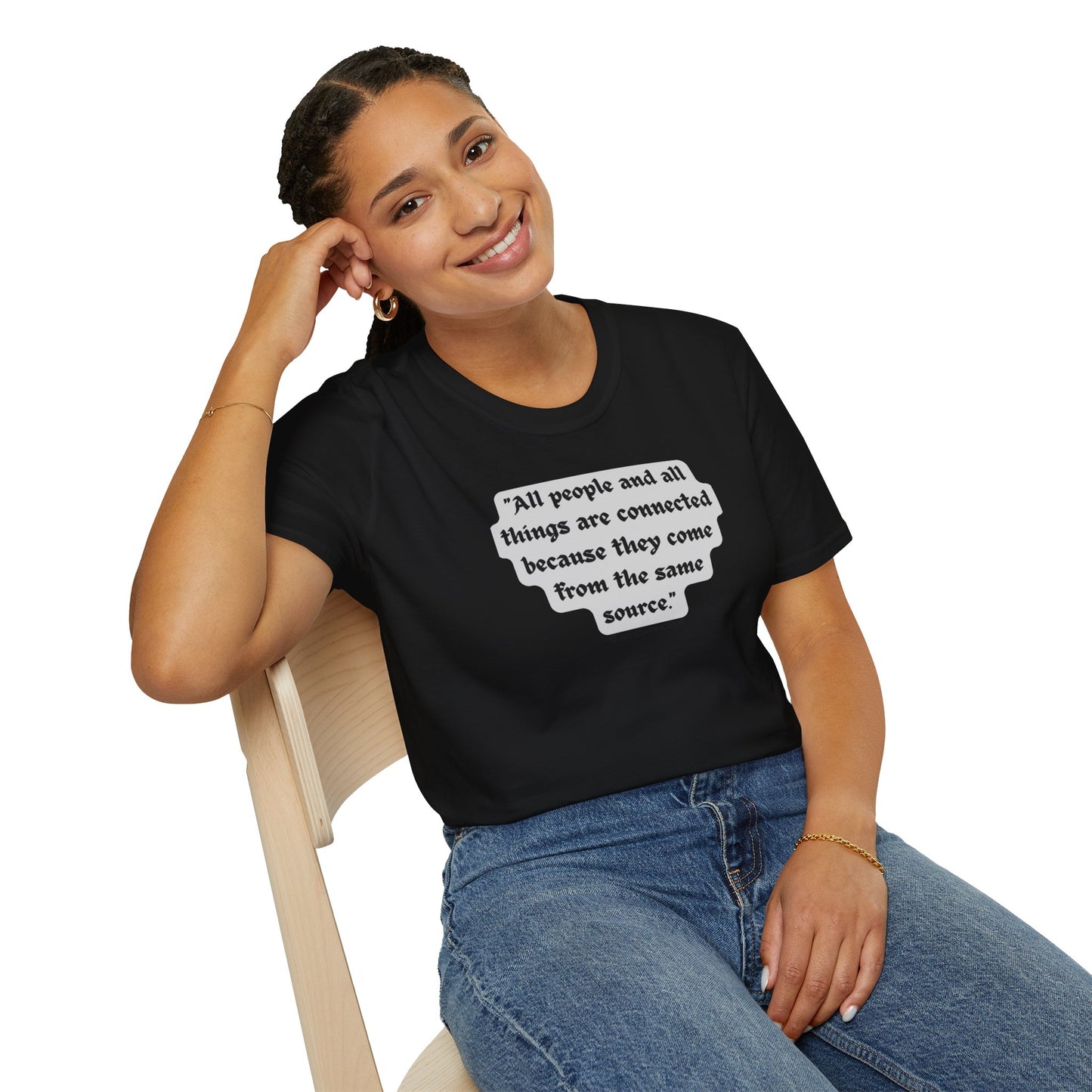 A smiling woman in a black shirt sits on a chair, showcasing the All People are Connected Gray Unisex T-shirt. The image captures a casual, comfortable vibe for this 100% cotton tee.