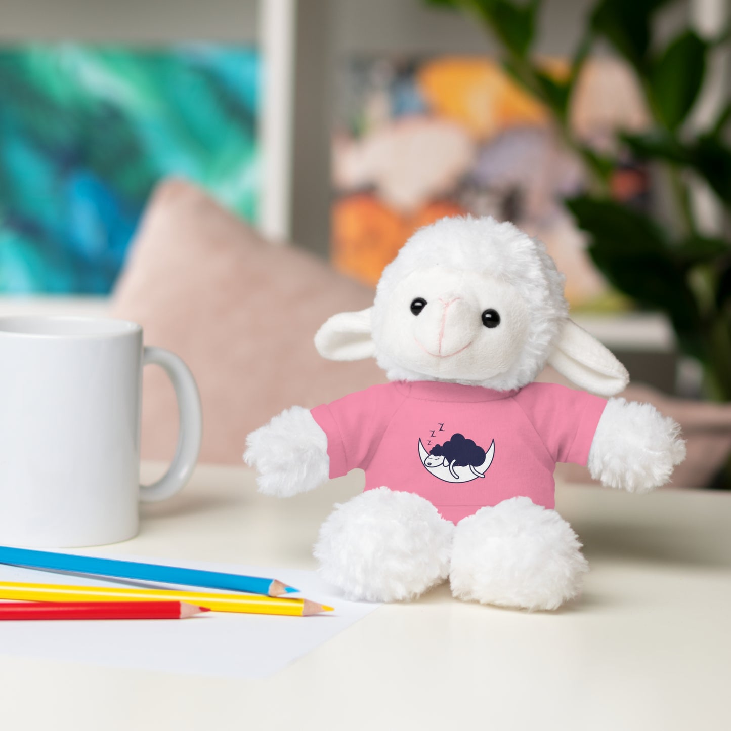 Sleep Sheep Stuffed Animal with shirt, sitting on a table, featuring a playful smile, soft plush body, and a cotton tee, perfect for kids aged 3+.