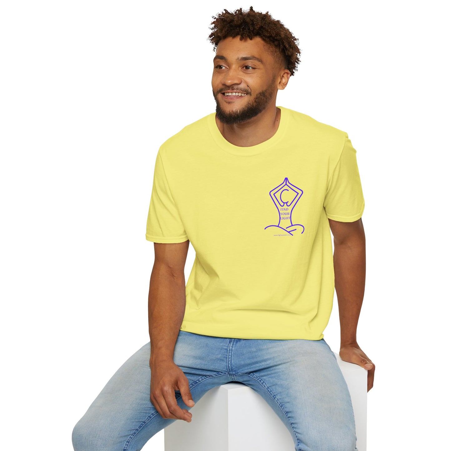 A man in a yellow shirt sits on a cube, showcasing the Yoga Find Your Light Unisex T-Shirt. Soft 100% cotton, twill tape shoulders, tear-away label, Eurofit, no side seams.