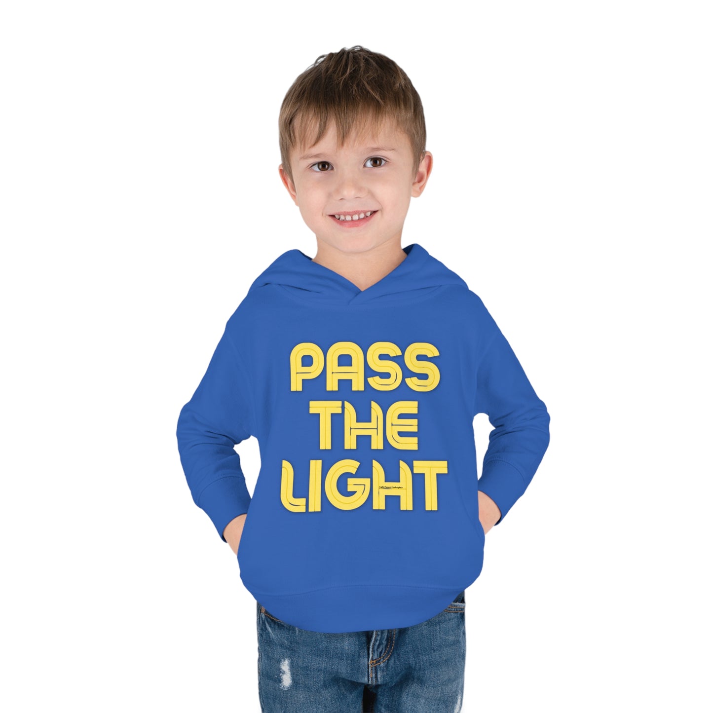 A toddler in a Pass the Light hoodie with jersey-lined hood, cover-stitched details, and side seam pockets for durability and coziness.