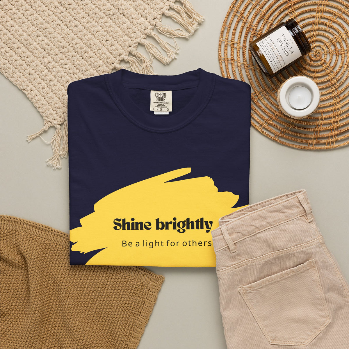 Unisex T-shirt in dark navy with yellow “Shine brightly” graphic, crew neck