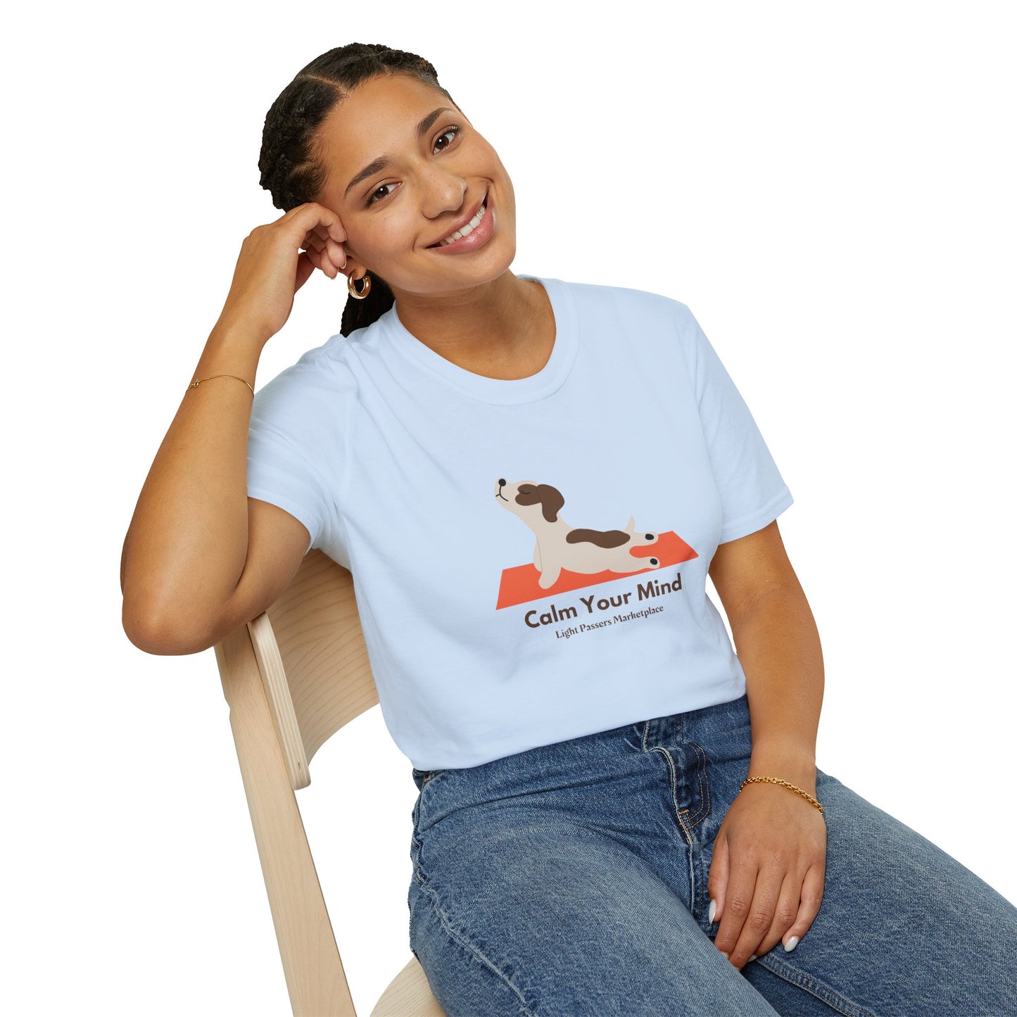 A woman in a white shirt sits on a chair, smiling, showcasing the Calm Dog Yoga Unisex T-shirt. Soft 100% cotton, twill tape shoulders, no side seams, ribbed collar. Ethically made, lightweight, versatile.