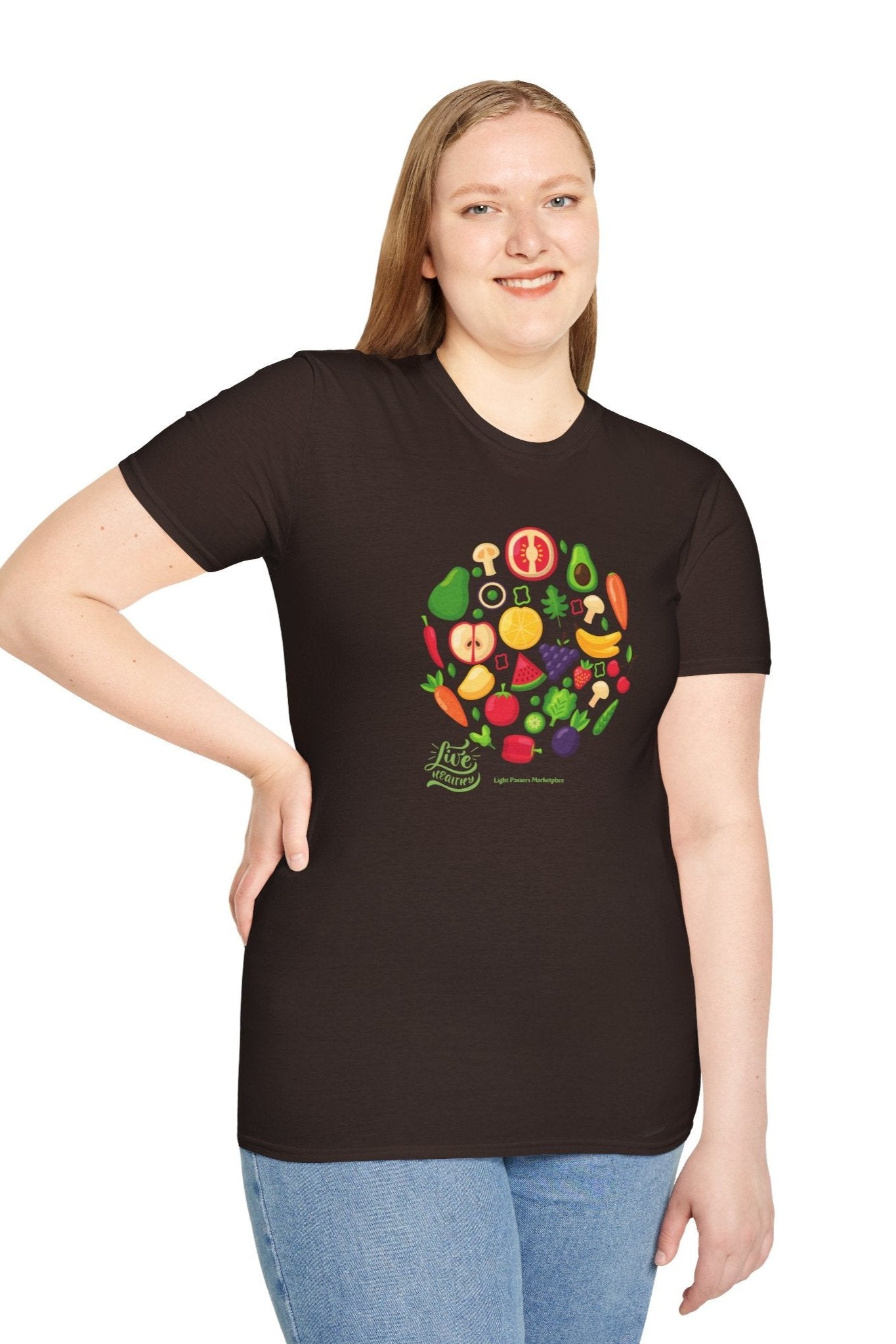 A woman in a black fruit design shirt smiles, showcasing the Live Healthy Unisex T-Shirt. The image features a casual, soft-style tee made of 100% ring-spun cotton for comfort and durability.