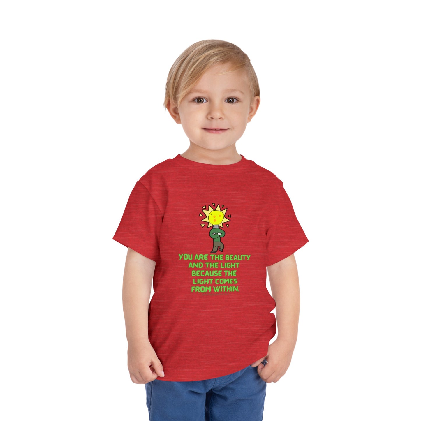 A toddler in a red shirt, featuring a light bulb cartoon, wears the Beauty and the Light Toddler T-shirt. Made of 100% Airlume cotton with tear-away label.