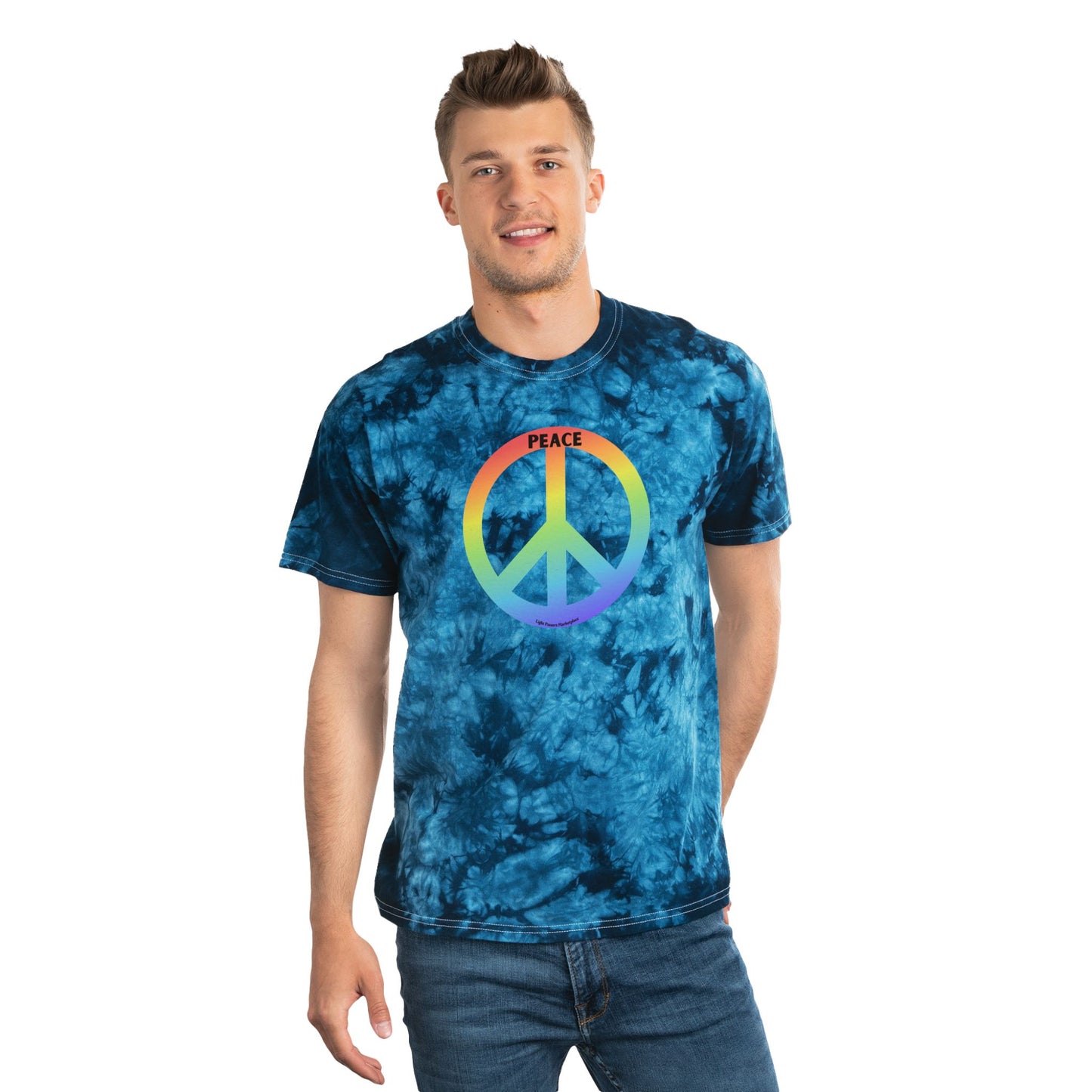 Young man in a navy tie-dye T-shirt with a rainbow peace symbol and PEACE text, embodying retro vibes from Light Passers Marketplace's inspirational collection.