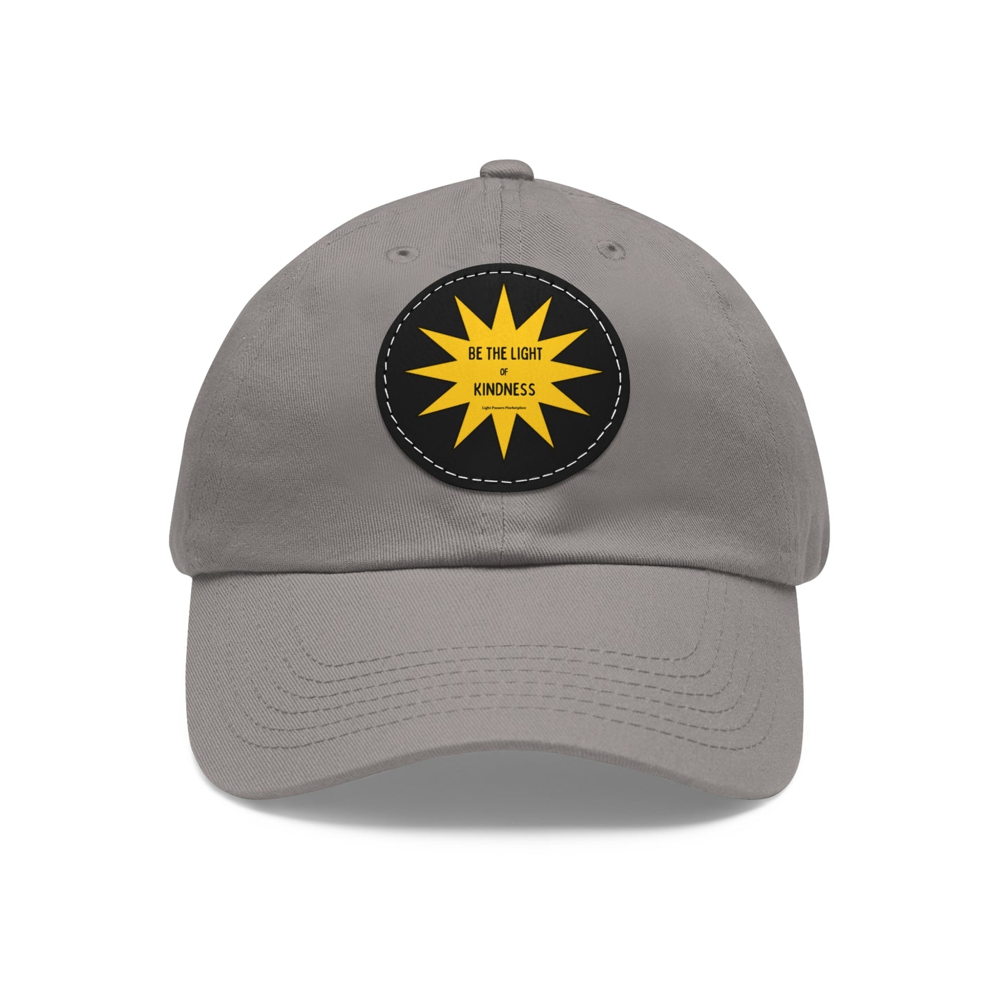 Unisex hat with 'Be the Light of Kindness' on a yellow sun patch, featuring a buckle closure and decorative stitching for a vintage look.