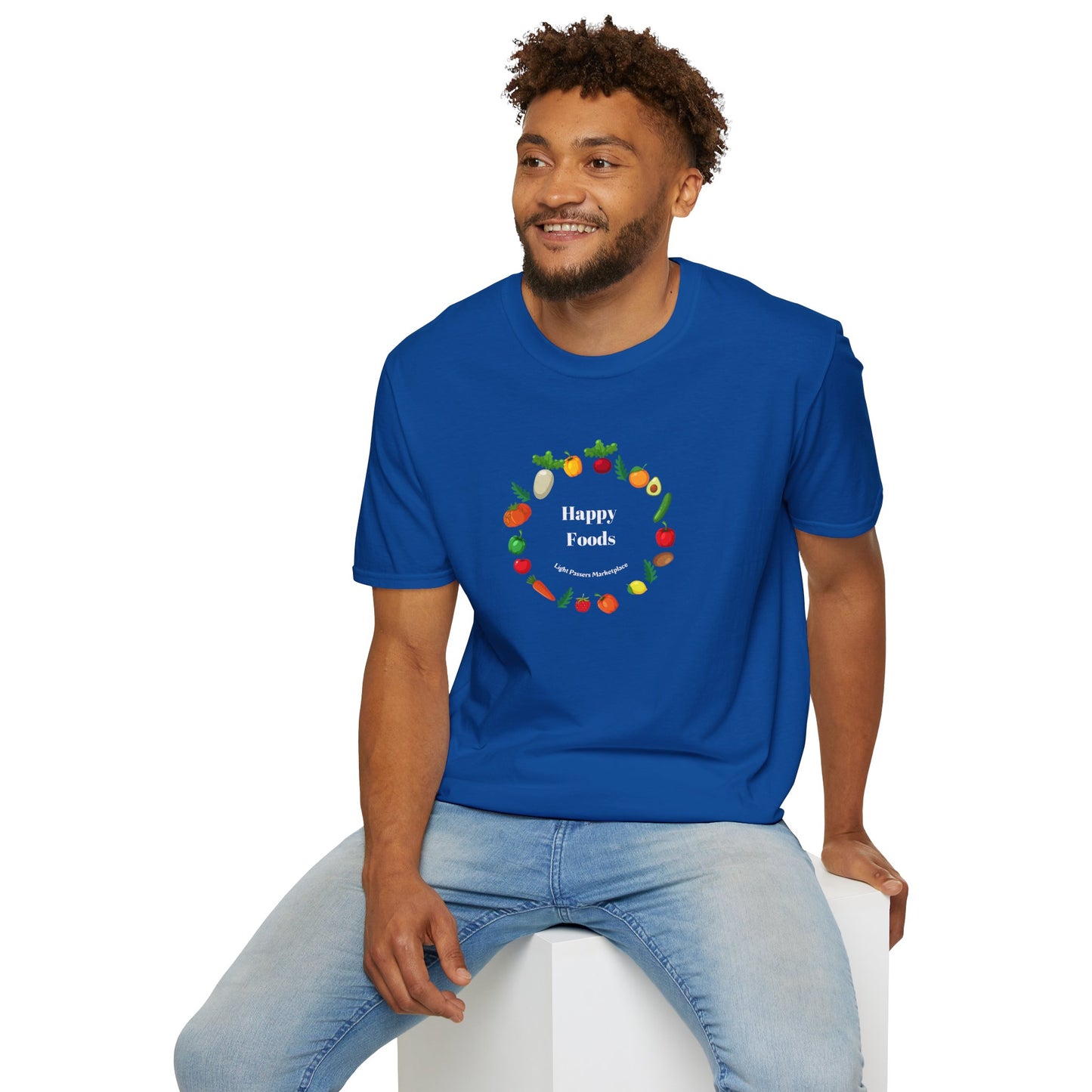 A man in a blue shirt sits on a cube, showcasing the Happy Foods Ring Unisex T-Shirt. Made of soft 100% cotton, featuring twill tape shoulders for durability and a clean crew neckline.