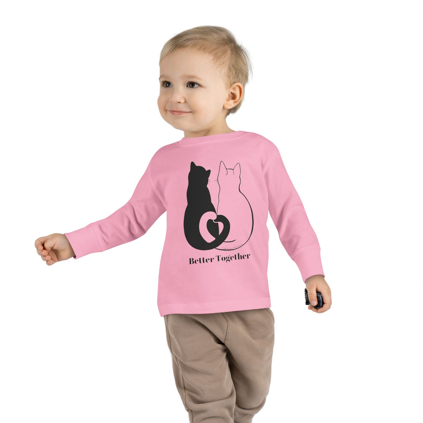 Toddler wearing a Better Together Cat Love Tails Long Sleeve featuring a cute cat design, showcasing the cozy fit and durable fabric.