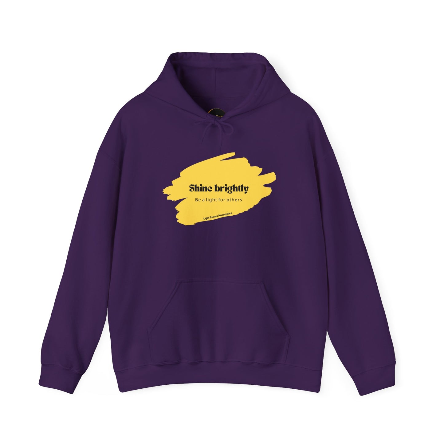 The Light Inspirational Hoodie - Shine Brightly Adult Unisex Heavy Blend™ Sweatshirt, featuring yellow paint accents and an uplifting message, ideal for warmth and style.