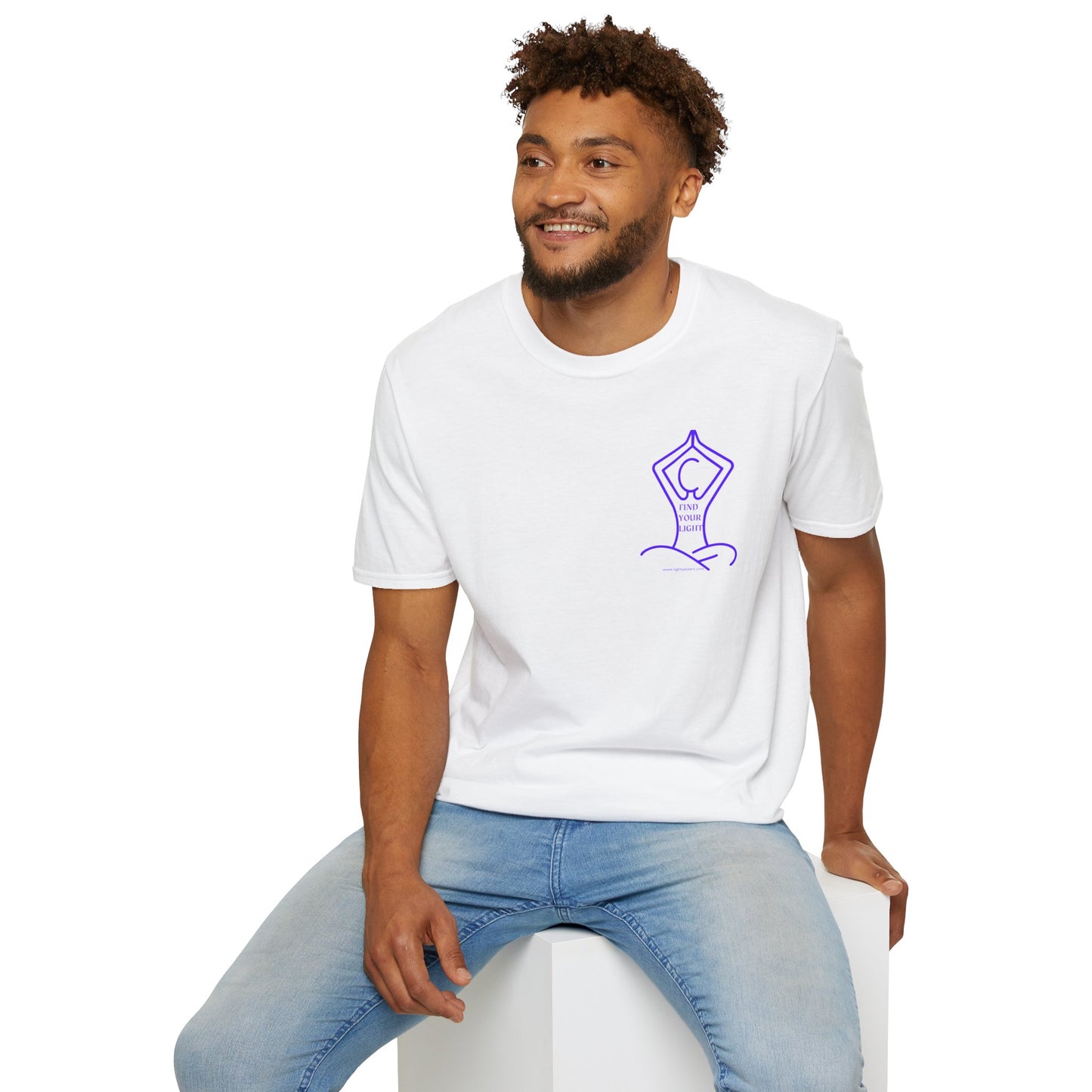 A man in a white shirt sits on a cube, showcasing the Yoga Find Your Light Unisex T-Shirt. Soft 100% cotton, twill tape shoulders, no side seams, ribbed collar.