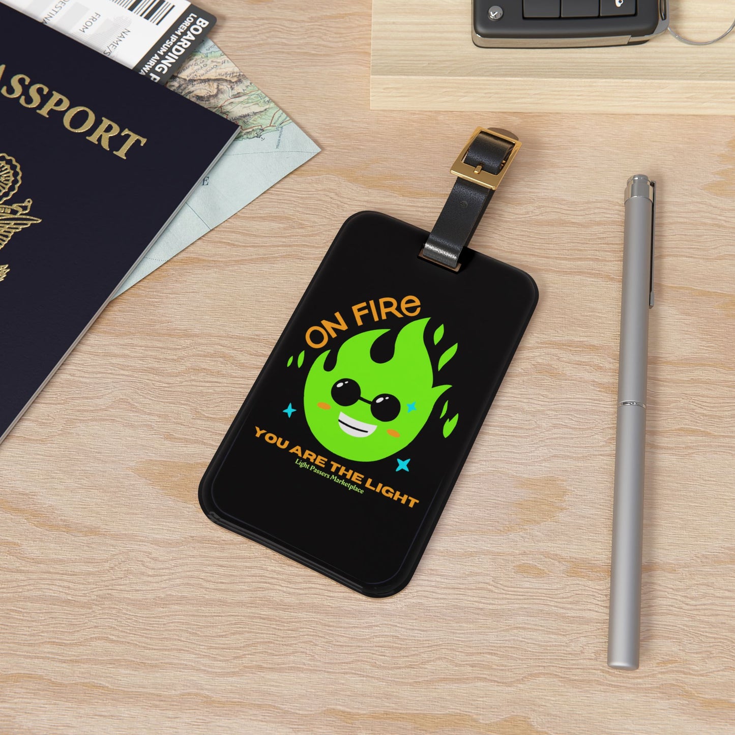 Luggage Tag On Fire You are the Light with green flame design, black strap, and durable acrylic material, perfect for inspiring positivity during travel.