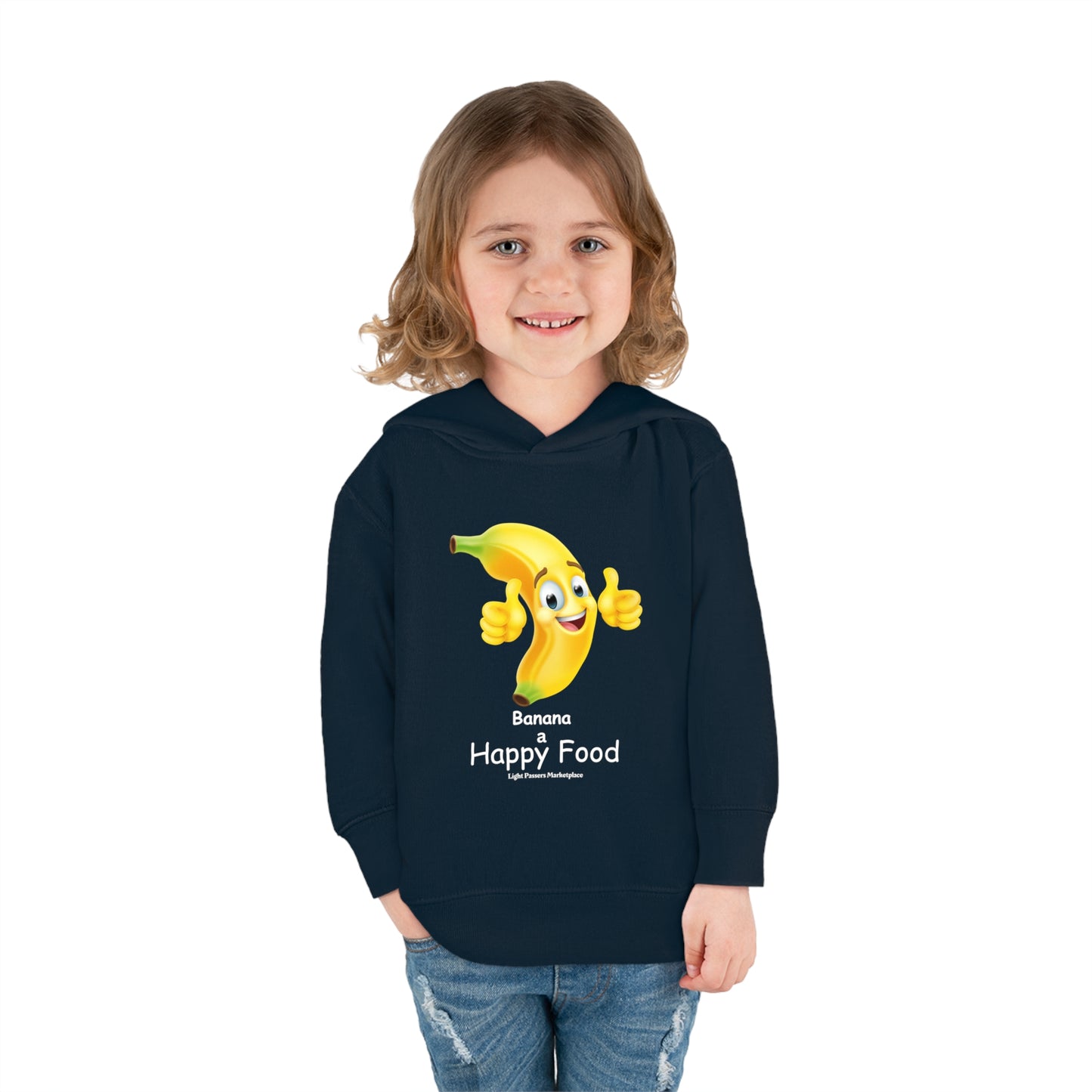 A child in a Rabbit Skins personalized toddler hoodie, smiling at the camera. Features jersey-lined hood, cover-stitched details, and side seam pockets for coziness. Banana Happy Food Toddler Hooded Sweatshirt.