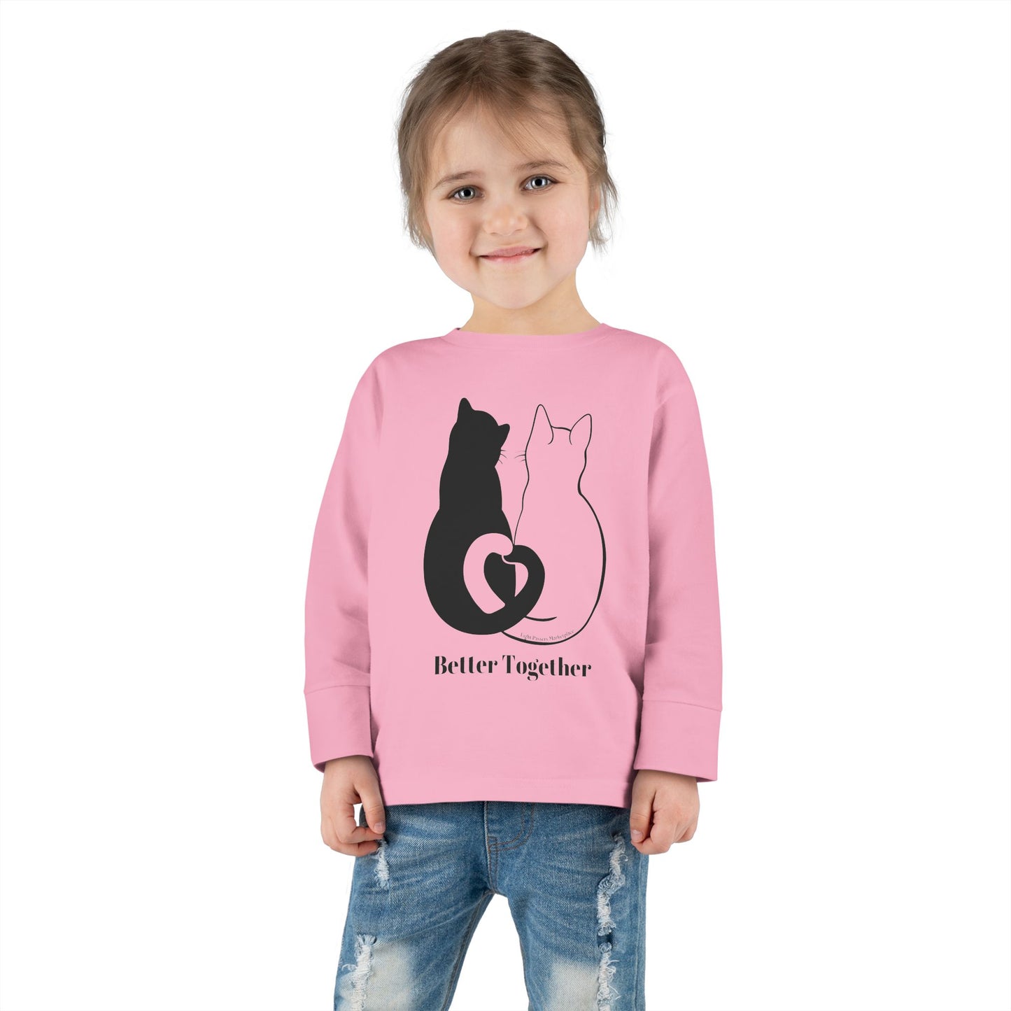 Toddler wearing Better Together Cat Love Tails Long Sleeve, showcasing cat-themed design on pink sweatshirt, emphasizing durability and comfort with topstitched collar and EasyTear™ label.