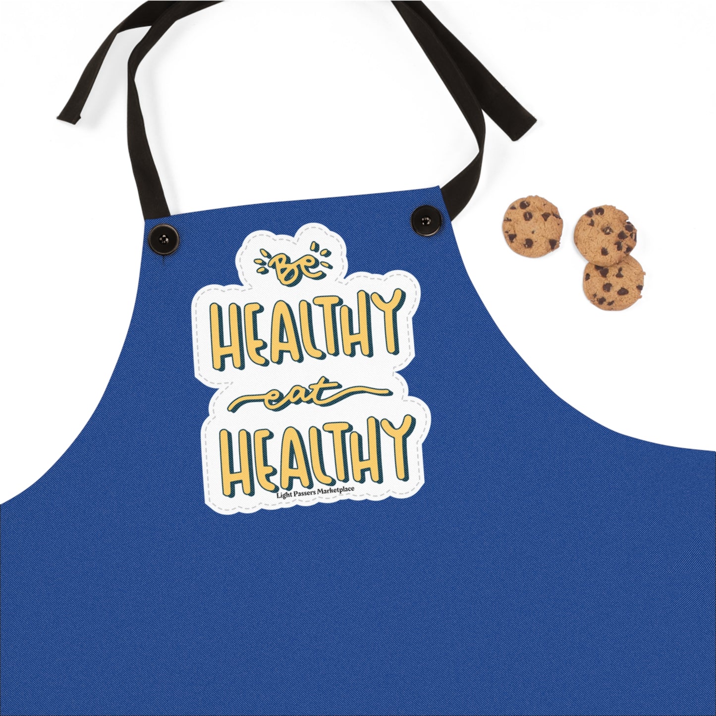Blue apron with black strap and two cookies, ideal for kitchen use. Features detachable straps, overlocked seams, and Be Healthy Eat Healthy design.