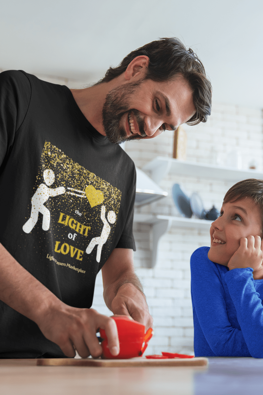 The Light Love and Peace Gold Heart Adult Unisex T-Shirt featuring a black base with white and gold text, worn by individuals smiling and interacting.