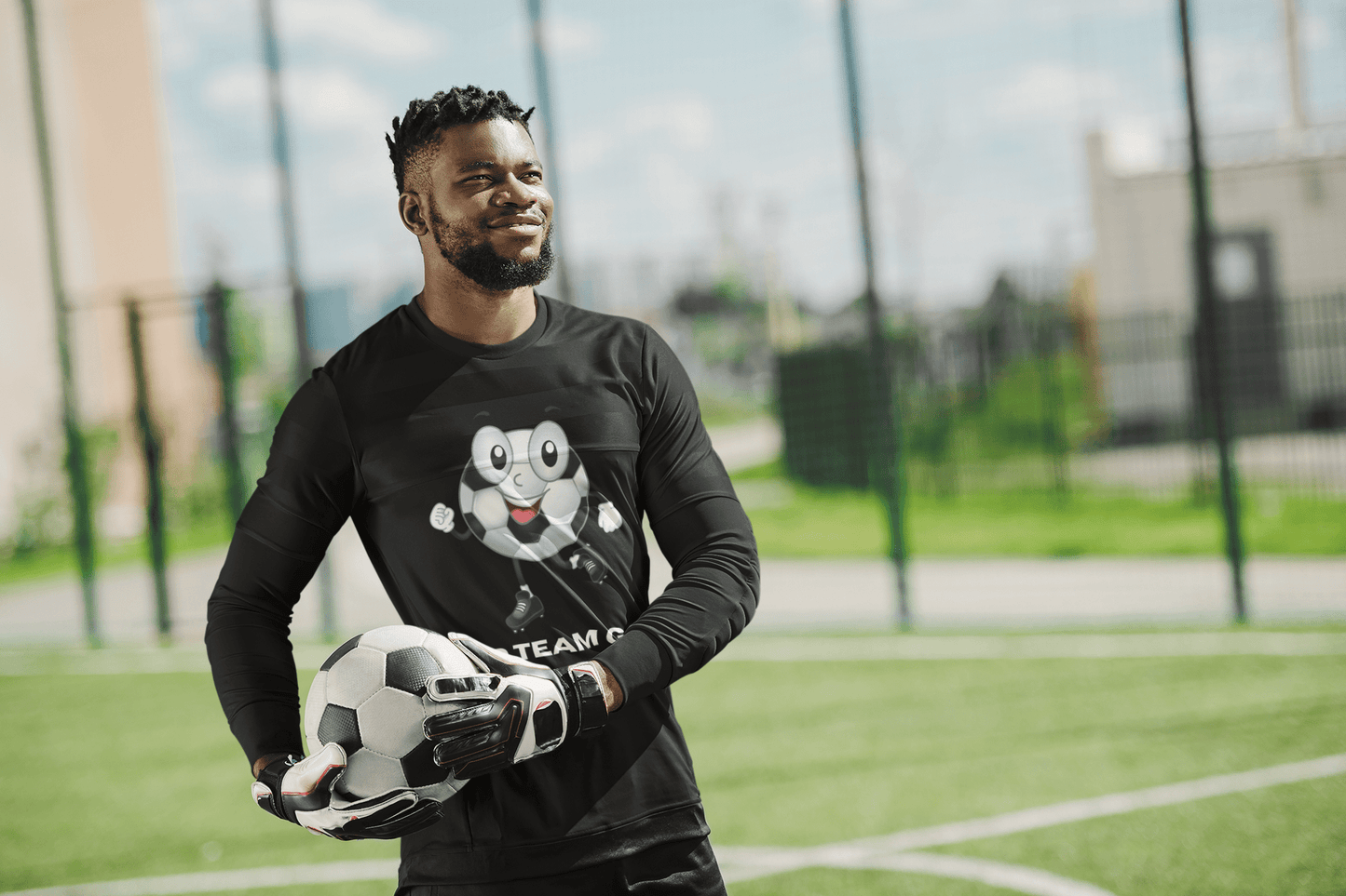 Man holding football with Soccer Ball Guy Long Sleeve Teams Adult Unisex shirt, showcasing sporty design and fit, ideal for soccer fans and events.