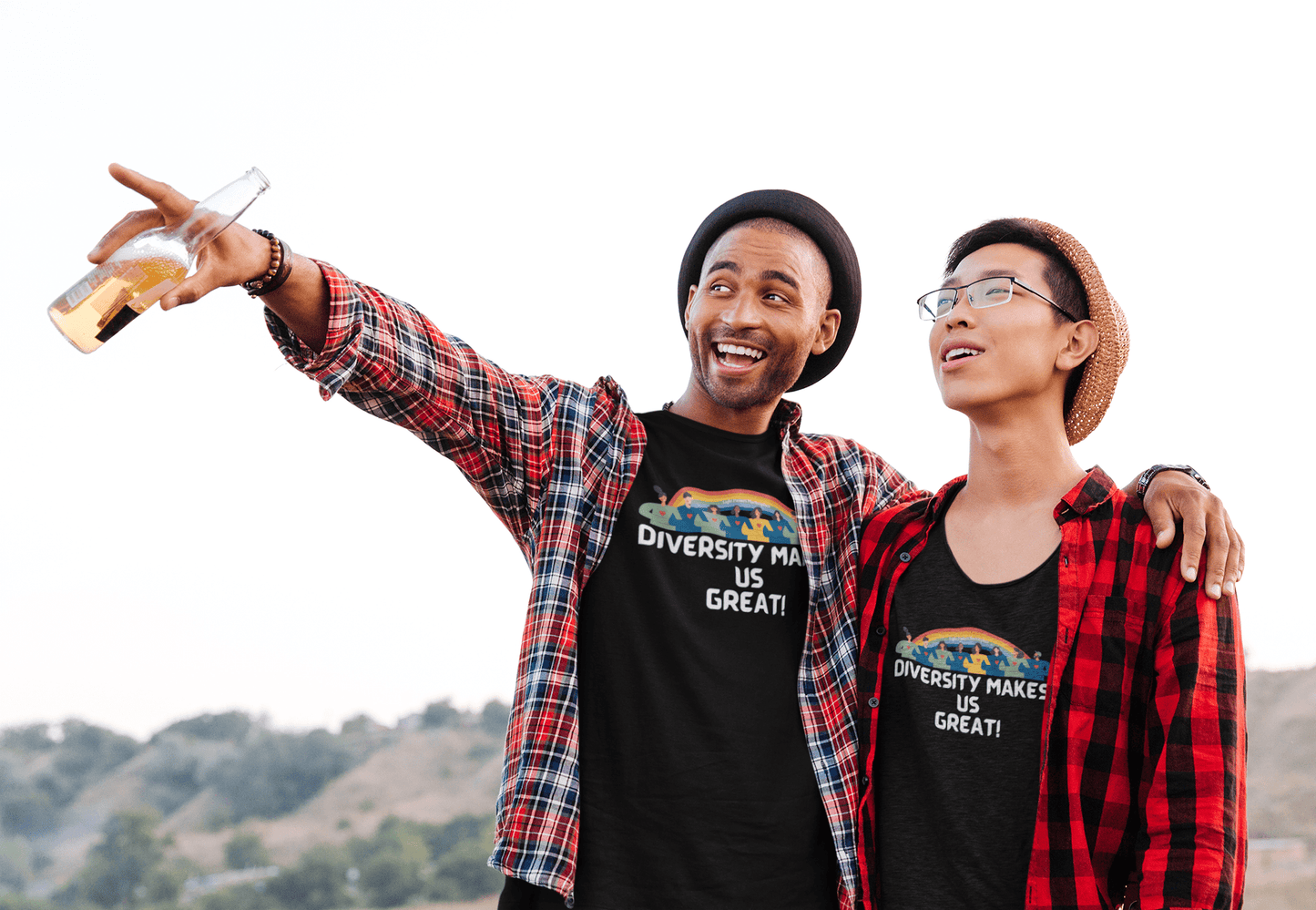Two men outdoors pointing, one in a hat and sunglasses, the other in a flannel shirt. Unisex heavy cotton tee with smooth surface for vivid printing, no side seams, and tape on shoulders for durability.