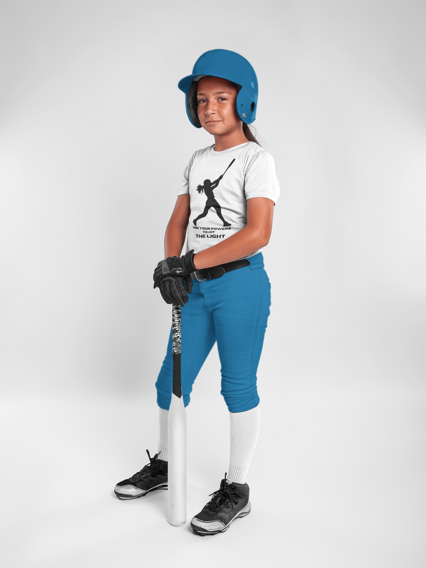 A girl in a baseball uniform holds a bat, showcasing the Girl Hit the Light T shirt Youth. Made of 100% cotton, with twill tape shoulders for durability and ribbed collar for curl resistance.