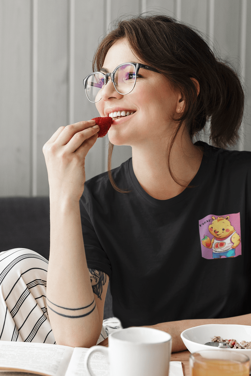 A woman enjoying a strawberry on a soft, 100% cotton unisex t-shirt. Classic fit with crew neckline for versatile style. Ethically made with tear-away label for comfort.
