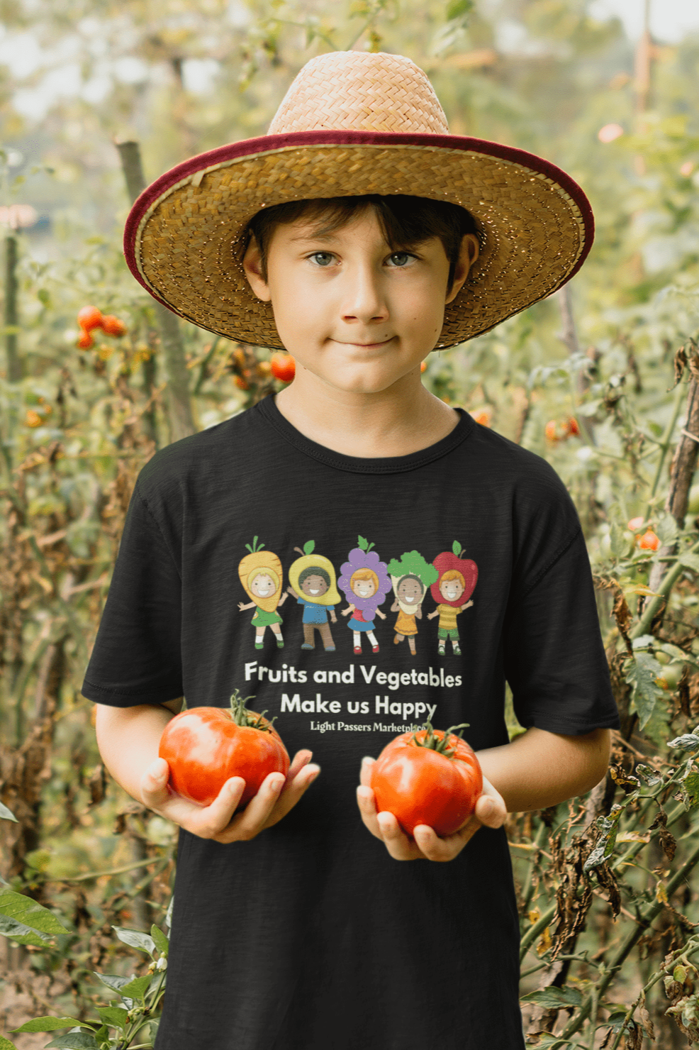 A boy in a garden holding tomatoes, wearing a straw hat. Fruits and Vegetables Make Us Happy Youth T-shirt: 100% cotton tee, durable twill tape shoulders, ribbed collar, ethically sourced US cotton, tear-away labels, Oeko-Tex certified.