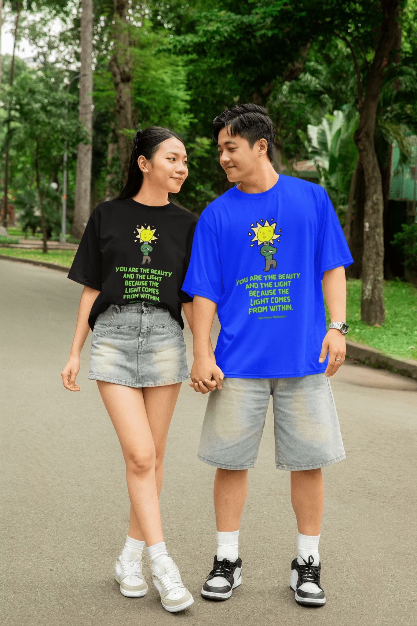 The Light Beauty and The Light Adult Unisex T-Shirt featuring an inspiring message, worn by a couple holding hands, showcasing casual and uplifting style.