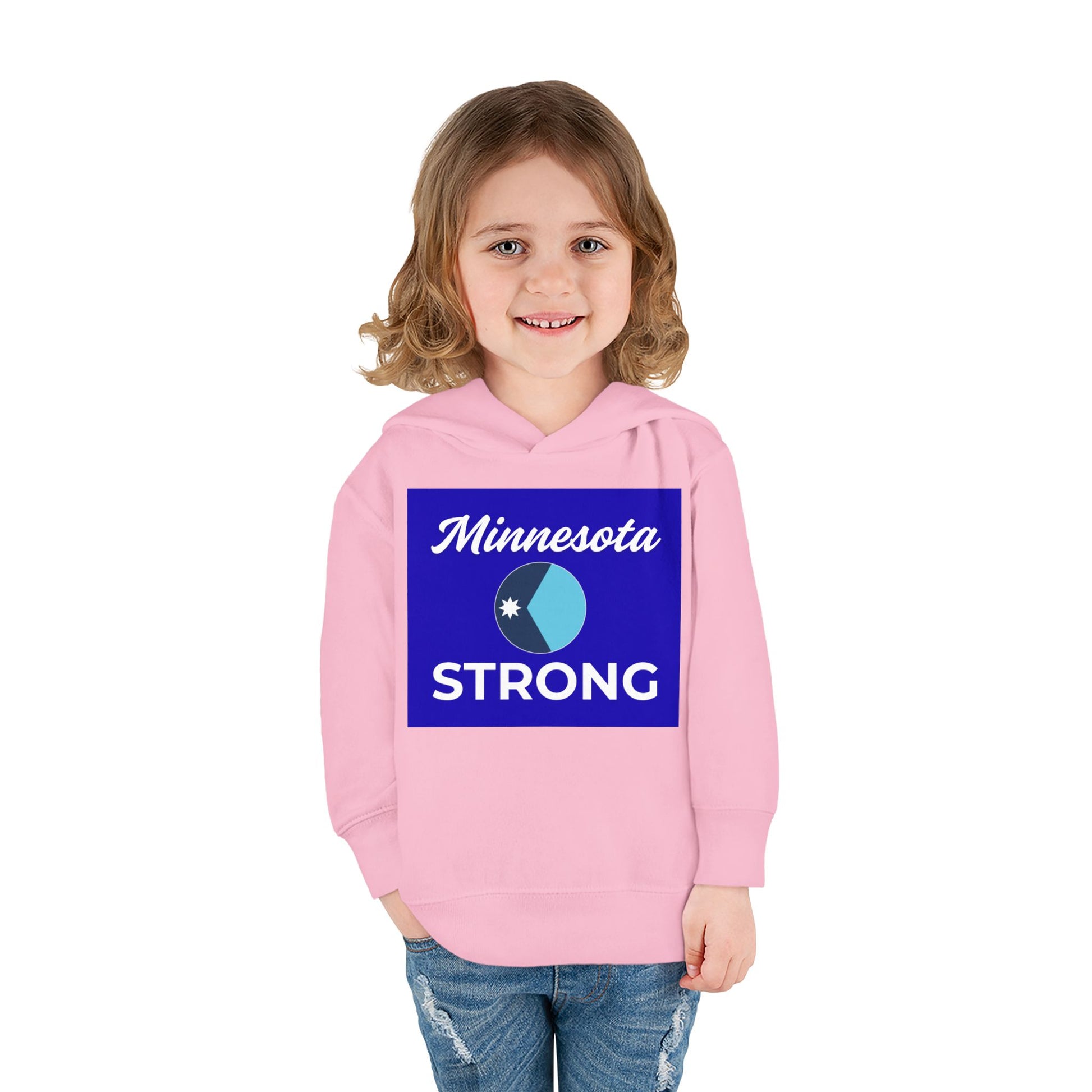 Toddler wearing Minnesota Strong hoodie, featuring blue graphic text, paired with jeans. Cozy, durable design ideal for playful, everyday wear.