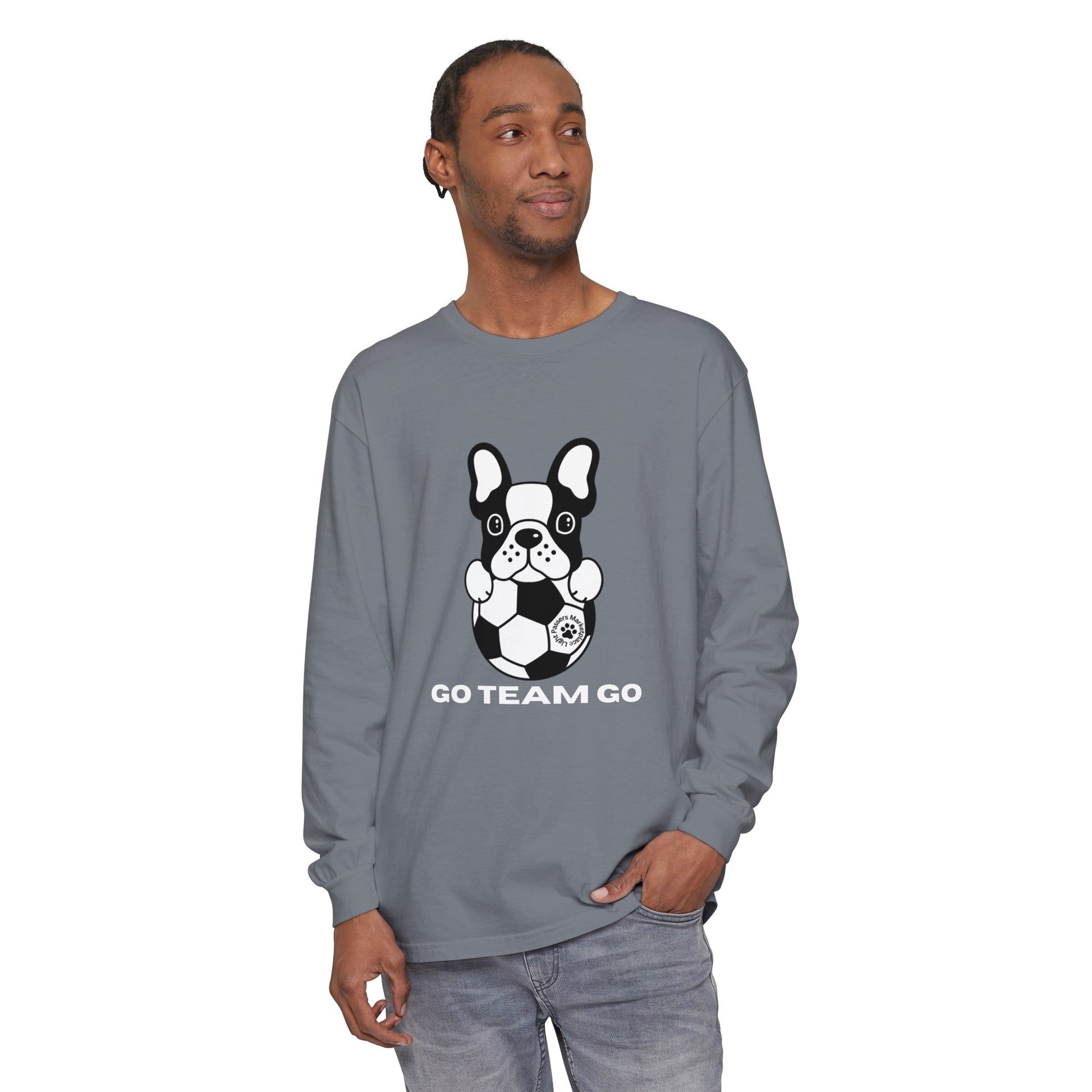 Man wearing Teams Soccer Dog Adult Unisex Garment-dyed Long Sleeve with dog and football design, showcasing its relaxed fit and casual style.