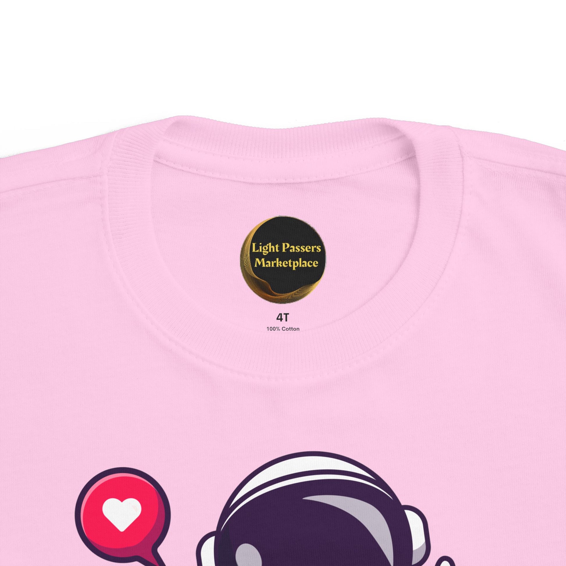 Peace Astronaut Toddler T-shirt featuring a cartoon astronaut helmet and heart icon, showcasing Light Passers Marketplace's inspirational design.