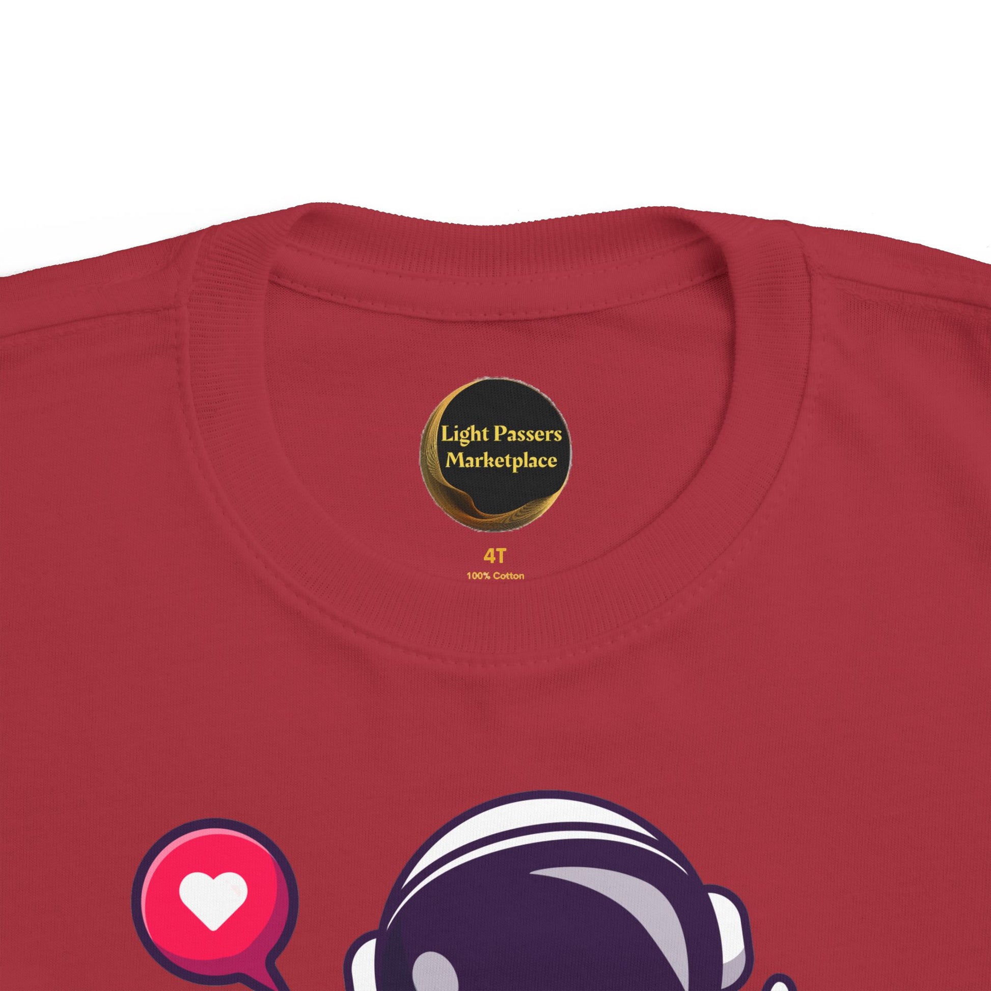 Peace Astronaut Toddler T-shirt featuring a cartoon astronaut helmet and heart speech-bubble, showcasing softness and durability. Circular Light Passers Marketplace label inside collar.