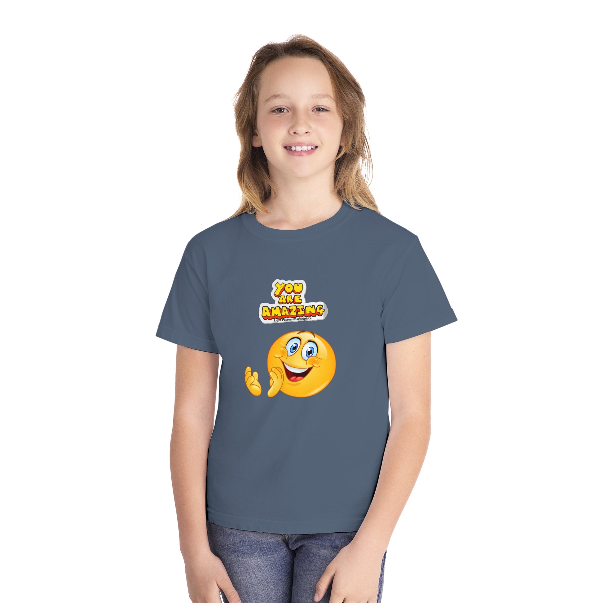 A youth t-shirt featuring a girl in a blue shirt, embodying comfort and agility. Made of 100% combed ring-spun cotton for all-day wear. Ideal for active kids.