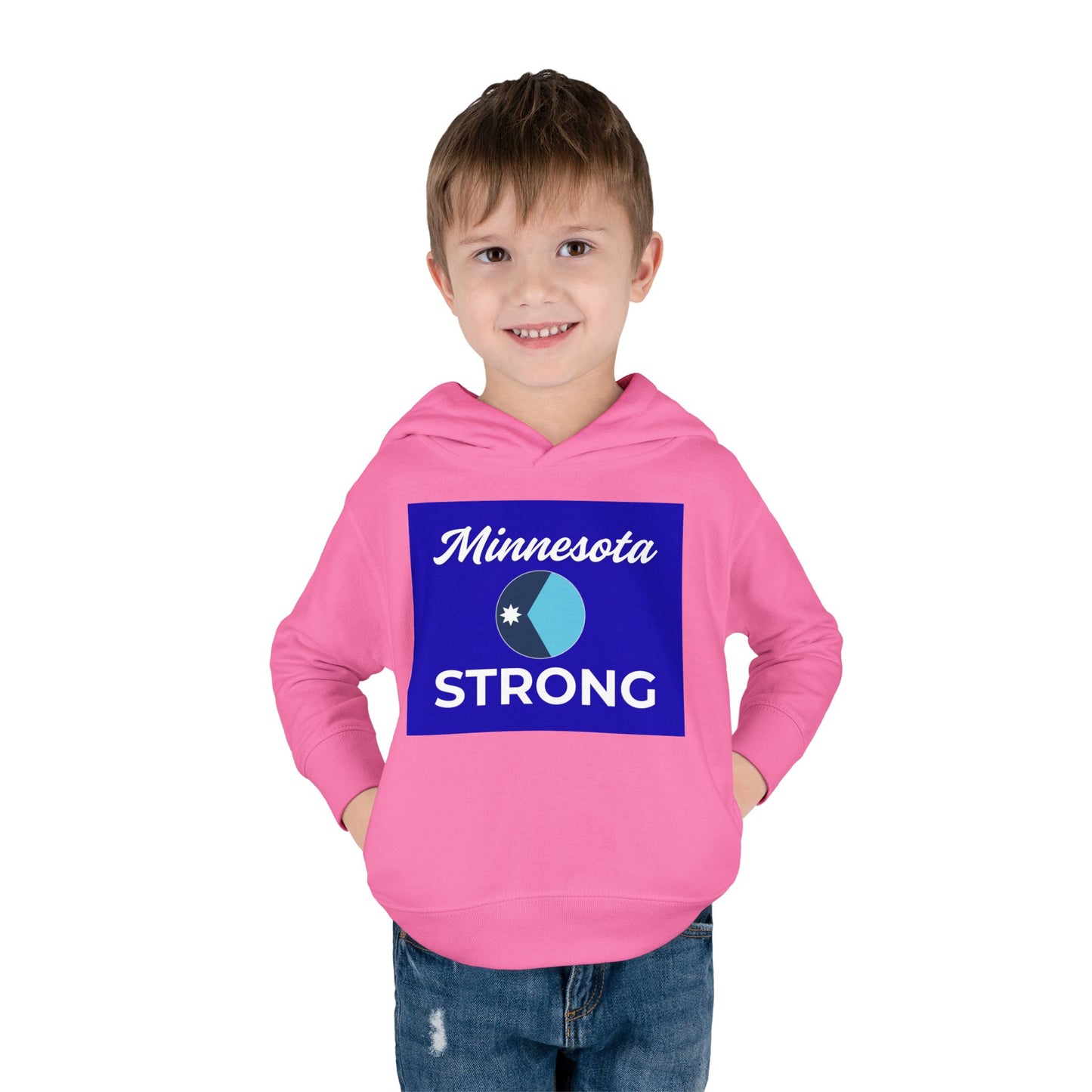 Young boy in a Minnesota Strong hoodie, smiling with hands in pockets, showcasing a cozy, durable design for warmth and comfort.