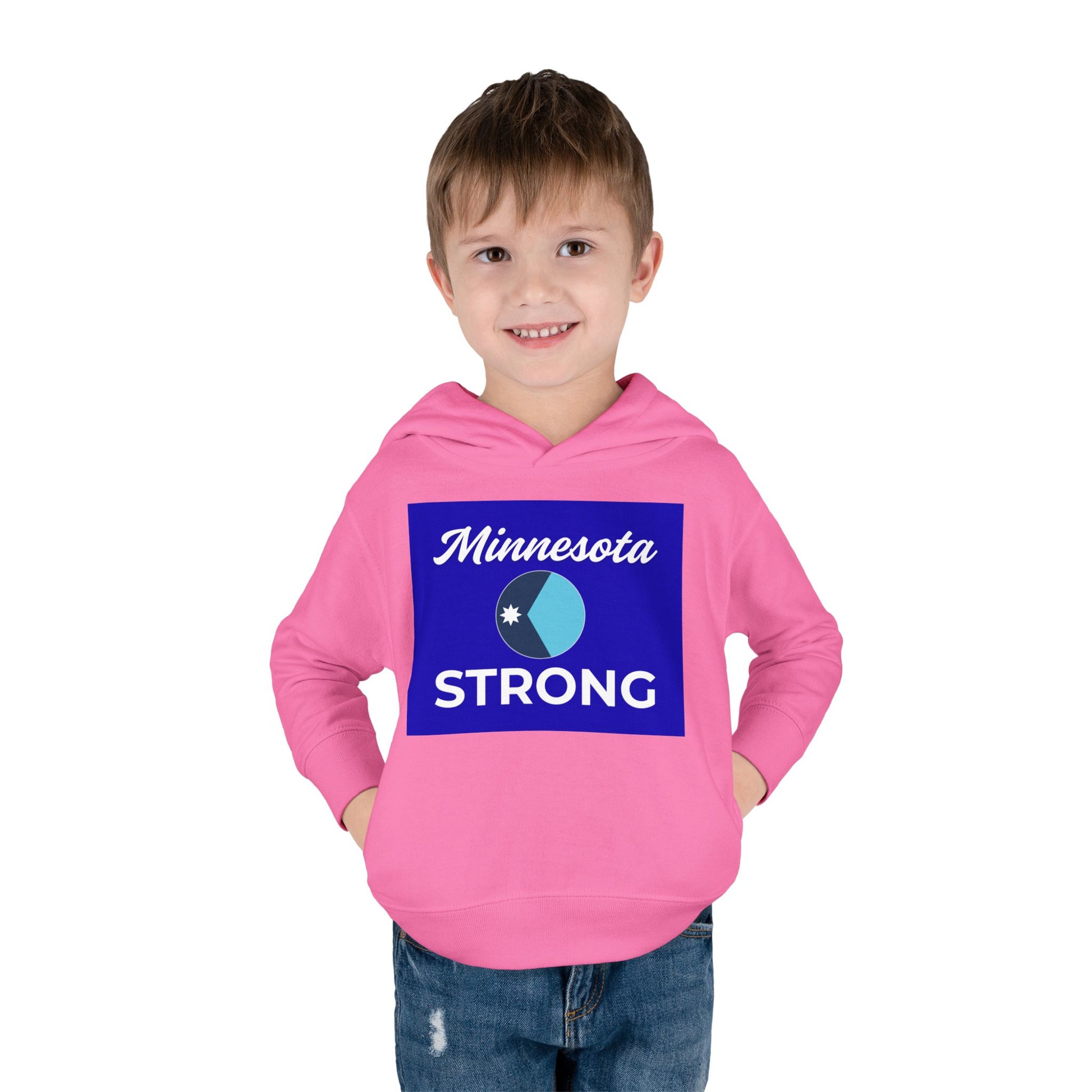 Young boy in a Minnesota Strong hoodie, smiling with hands in pockets, showcasing a cozy, durable design for warmth and comfort.