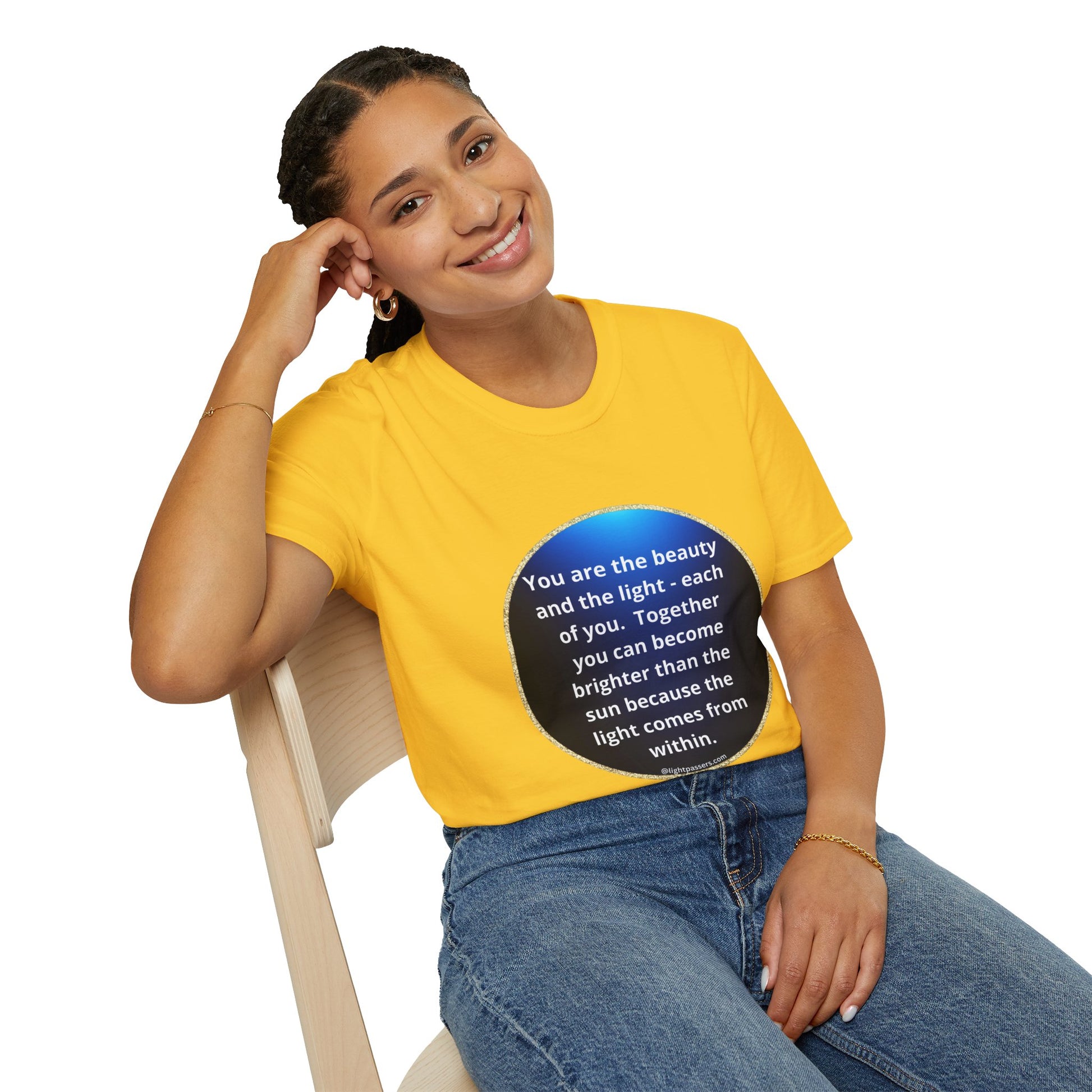 A woman in a navy circle unisex t-shirt sits on a chair, showcasing the classic fit and smooth fabric ideal for personalized designs. No side seams for added comfort.