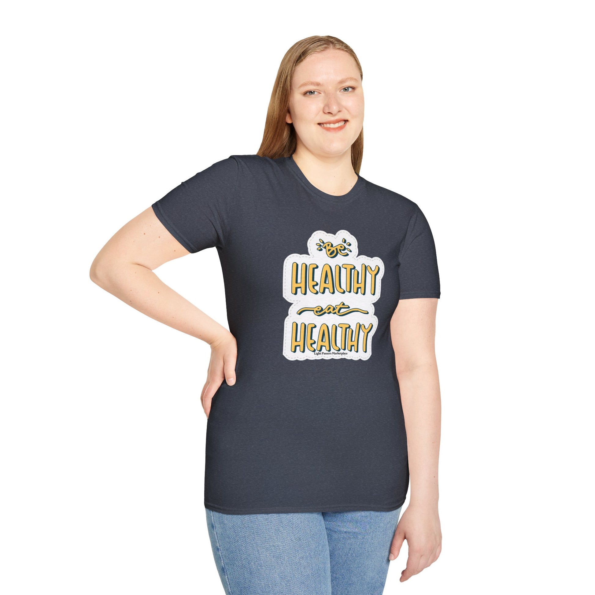 A woman in a Be Healthy Eat Healthy unisex t-shirt, showcasing the classic fit and soft cotton fabric. Twill tape shoulders, ribbed collar, and tear-away label for comfort. Ethically made with US cotton.