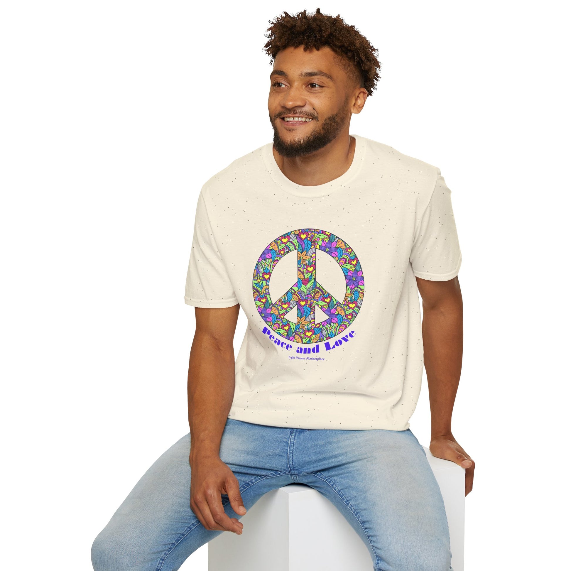 A man in a Peace sign with colorful flowers Unisex T-shirt, showcasing casual comfort in 100% cotton fabric with twill tape shoulders and ribbed collar.