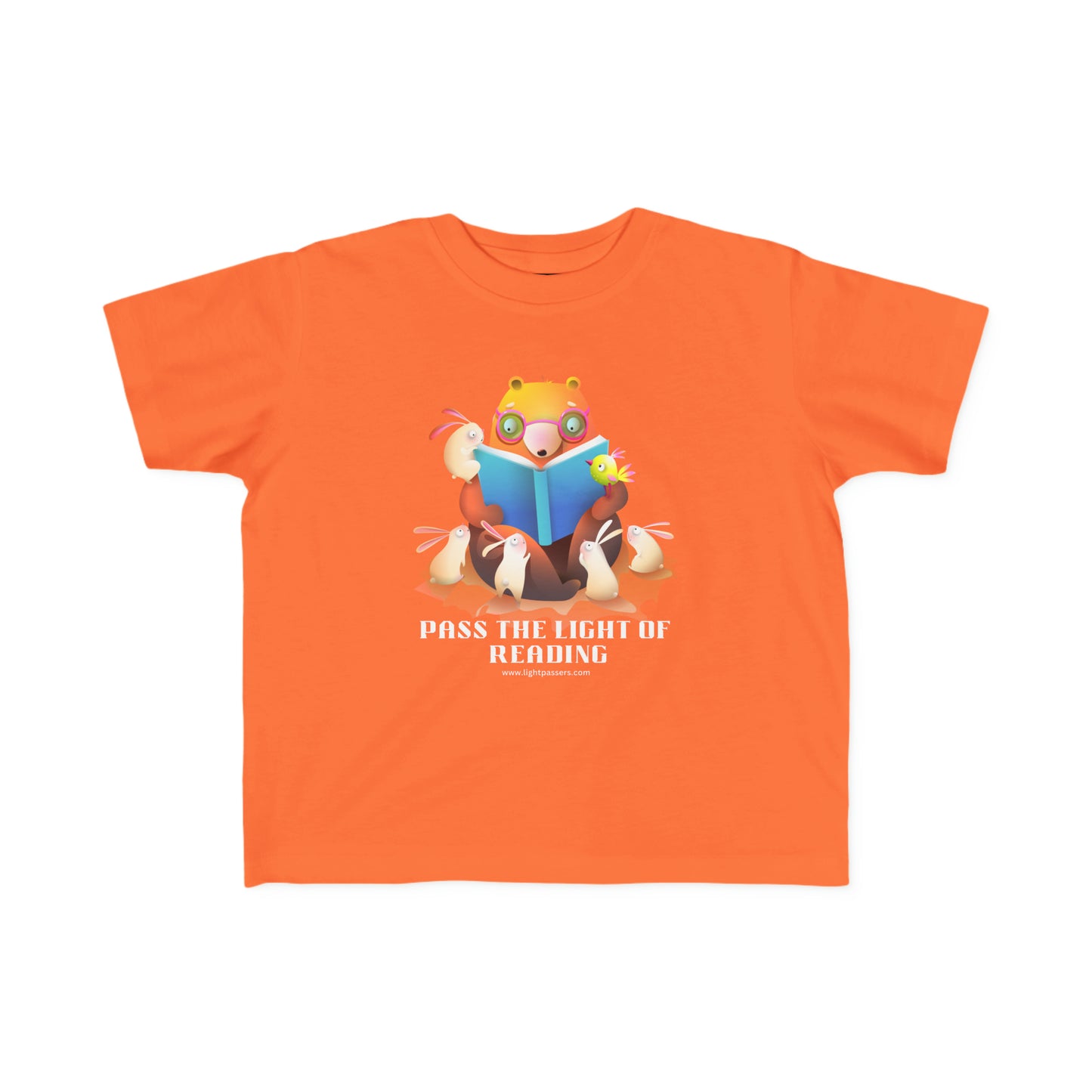 A toddler's tee featuring a cartoon bear reading a book, embodying the joy of reading. Soft 100% combed cotton, durable print, tear-away label, and a classic fit.