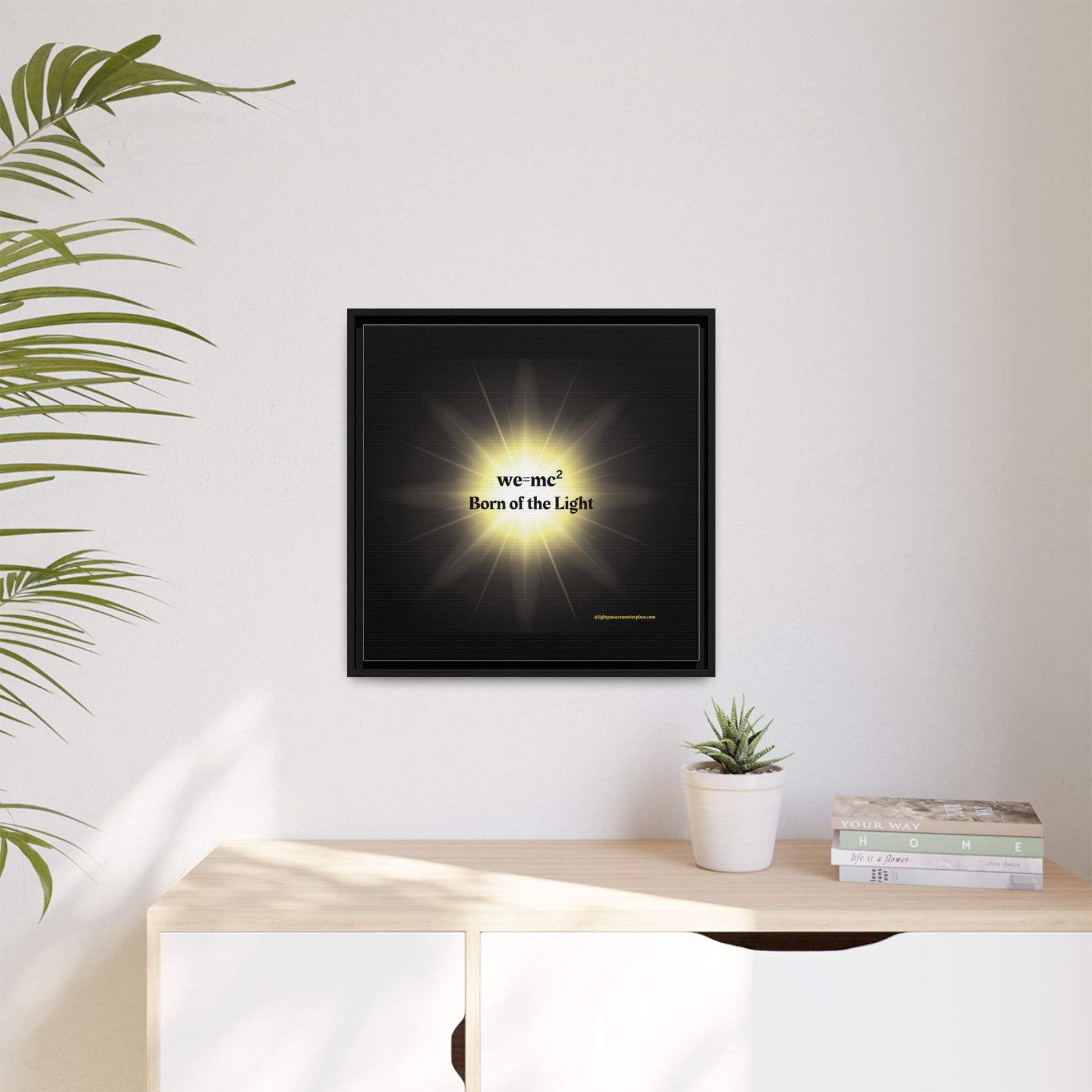 Inspirational Framed Canvas Art - we=mc² Born of the Light, showcasing a potted plant beside it, enhancing a motivational and creative ambiance.