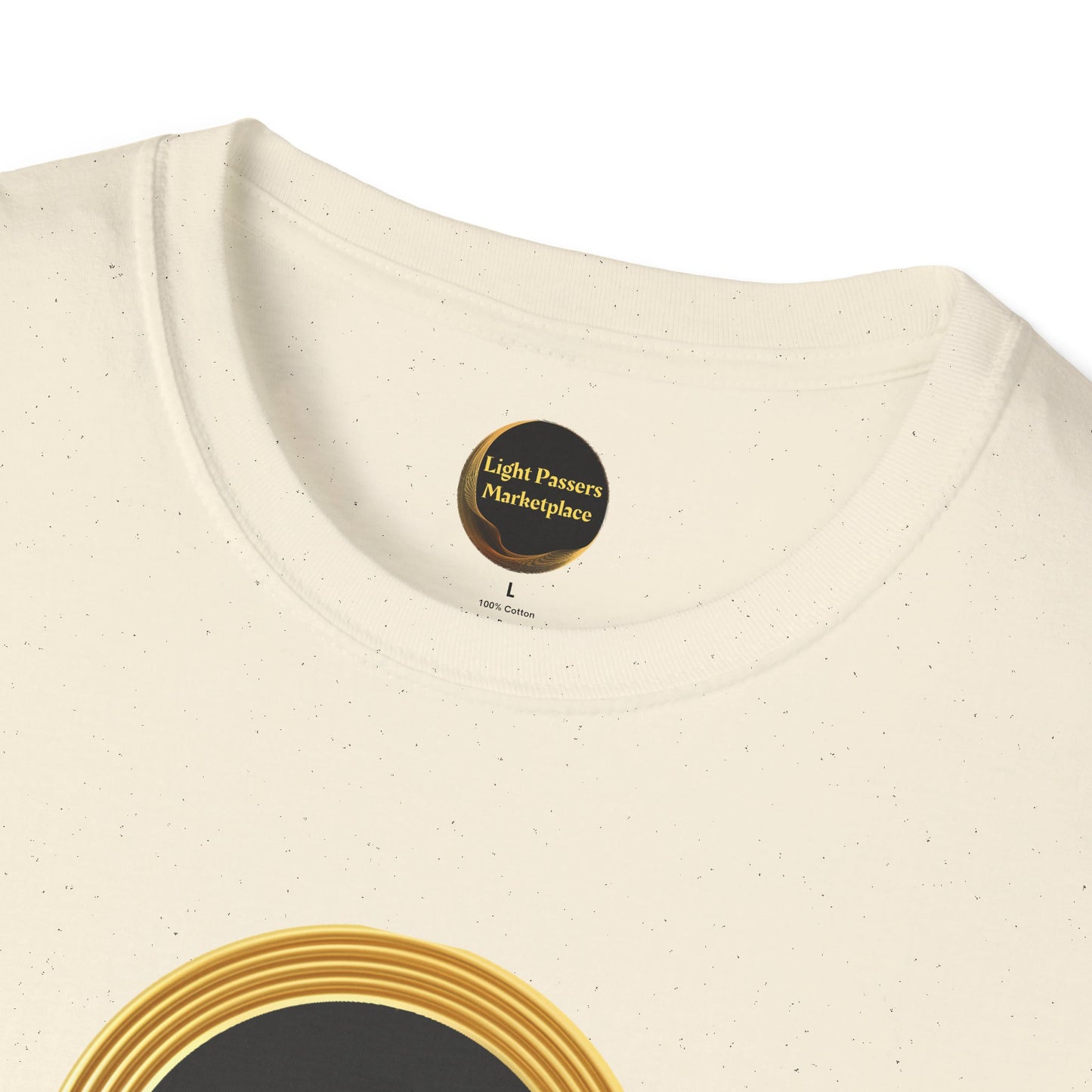 Close-up of the Empowerment Tee featuring Light Passers Marketplace label, size L, and a gold-and-black concentric design, emphasizing unity and empowerment.