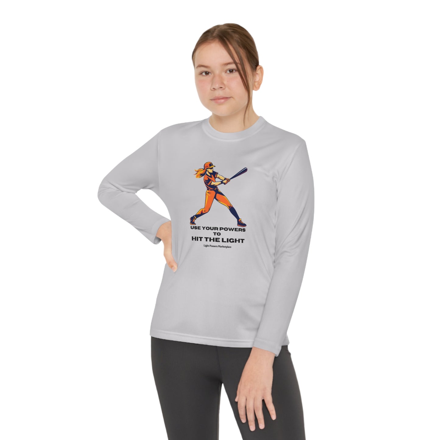 A girl in a long-sleeved tee swings a bat, embodying active comfort. Made of moisture-wicking polyester with PosiCharge ® tech, this lightweight tee is perfect for active kids.