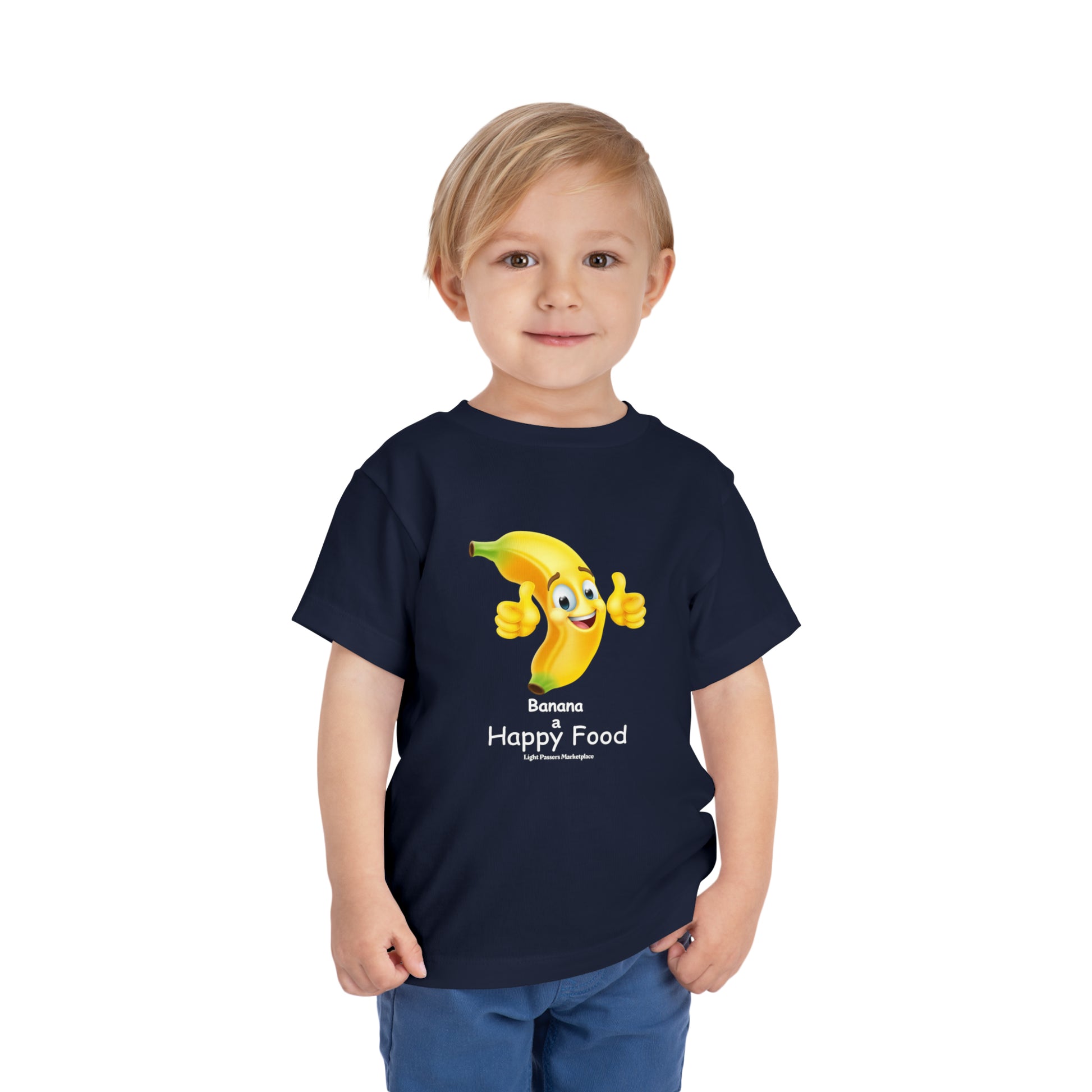 A toddler in a blue shirt with a cheerful banana cartoon, featuring a thumbs-up gesture. Bella Canvas 100% cotton tee with tear-away label for comfort.