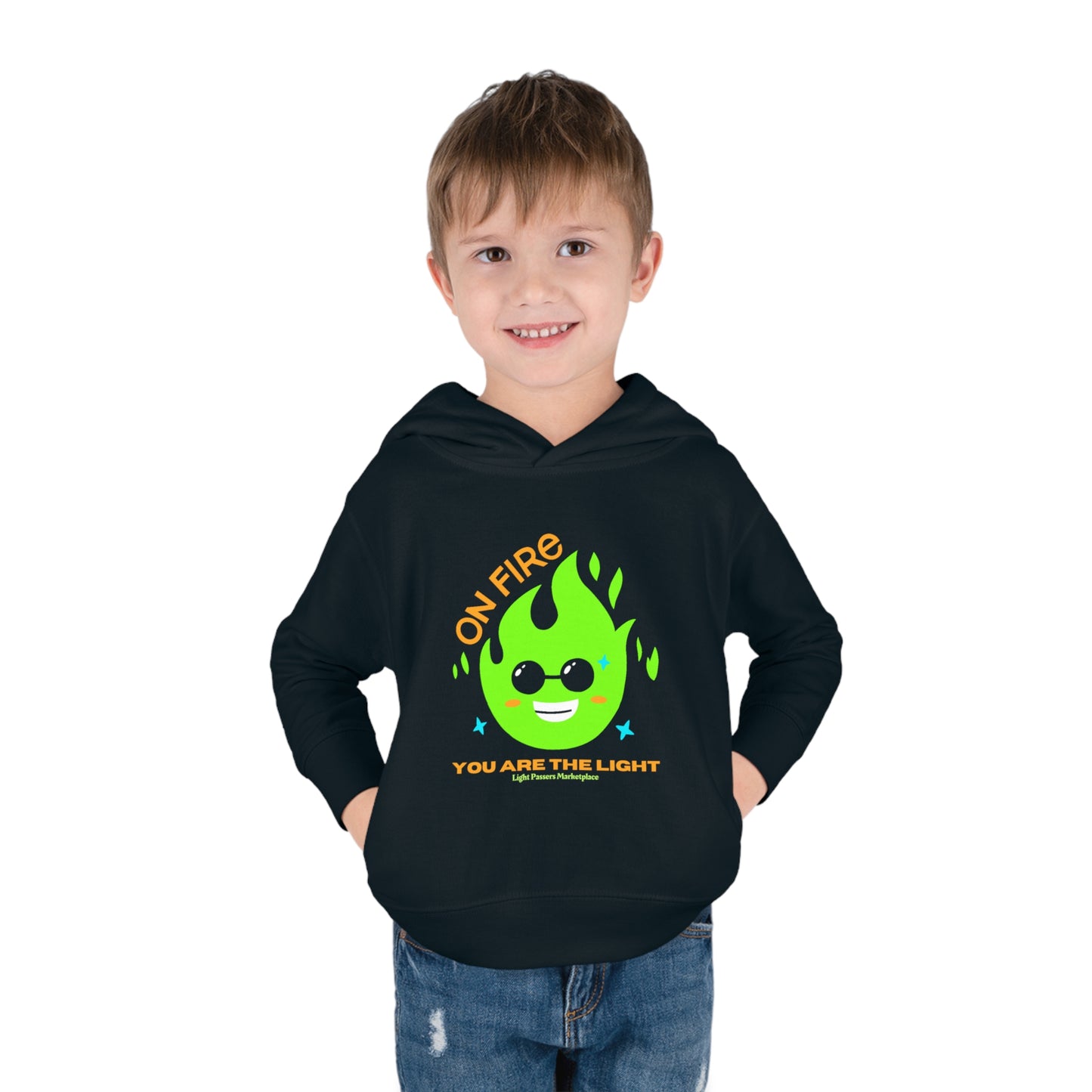 A toddler wearing a black hoodie with a green flame design, smiling. Features jersey-lined hood, cover-stitched details, side seam pockets, and durable fabric blend for lasting coziness.