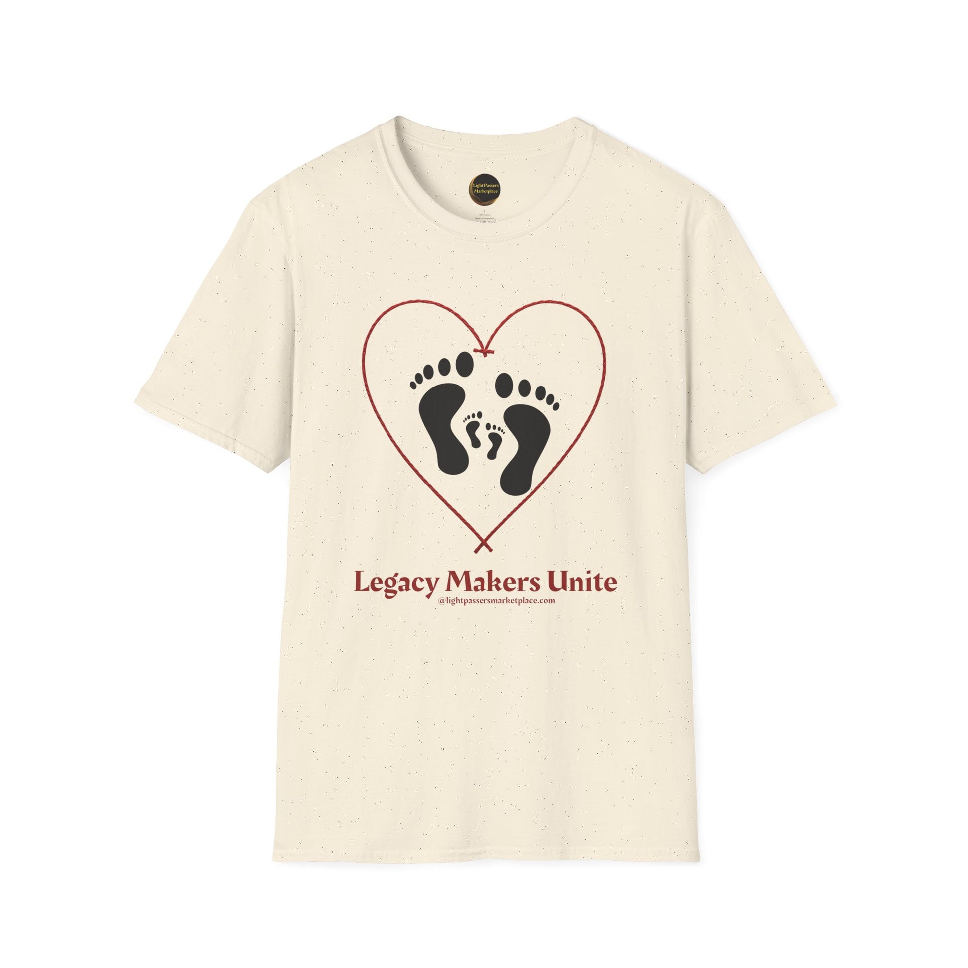 Cream-colored T-shirt with Legacy Makers Unite slogan, featuring heart graphic with adult and child footprints, promoting love, peace, and sustainability.