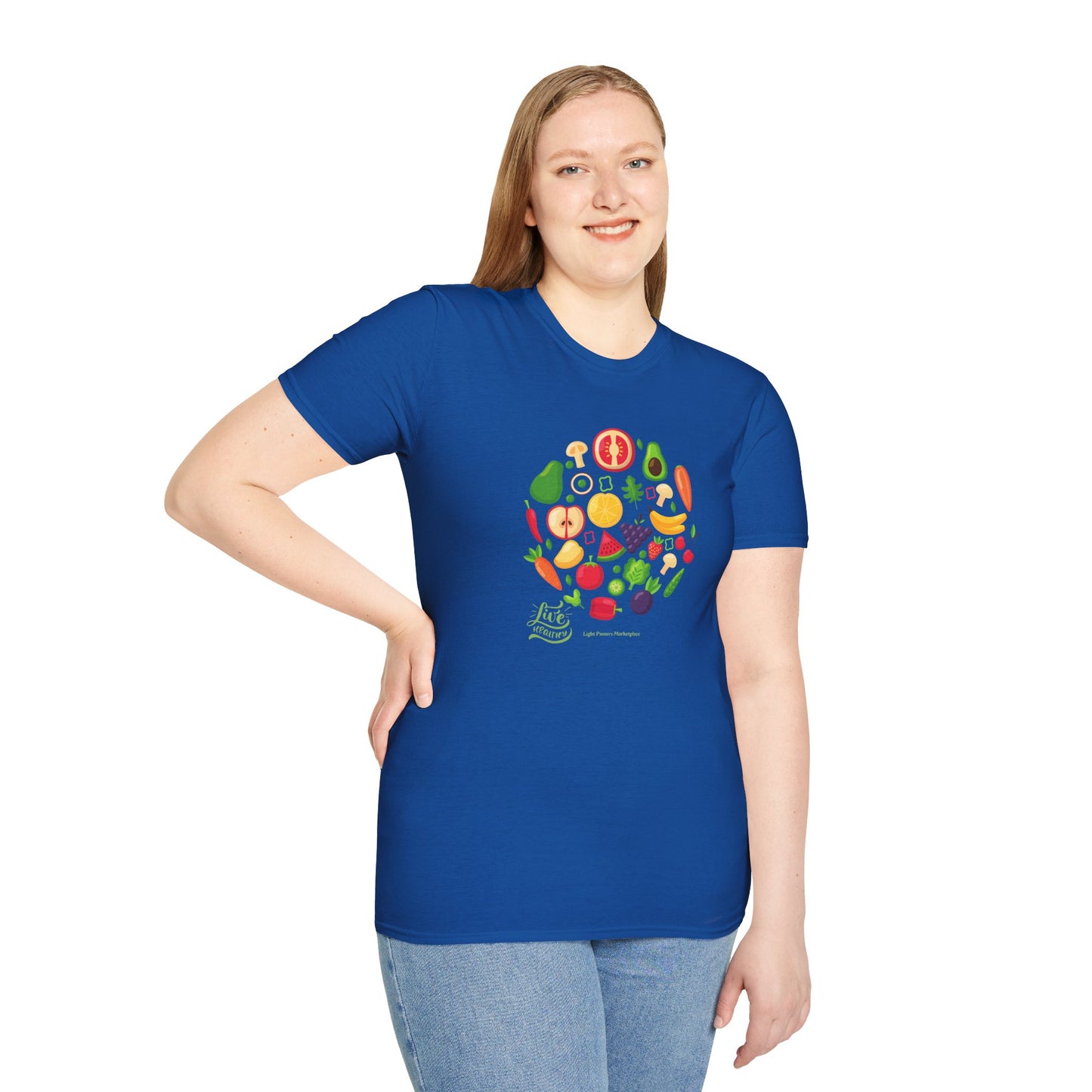A woman in a blue shirt with a fruit design, smiling at the camera. Unisex soft-style t-shirt made of 100% ring-spun cotton, featuring twill tape shoulders and ribbed collar.