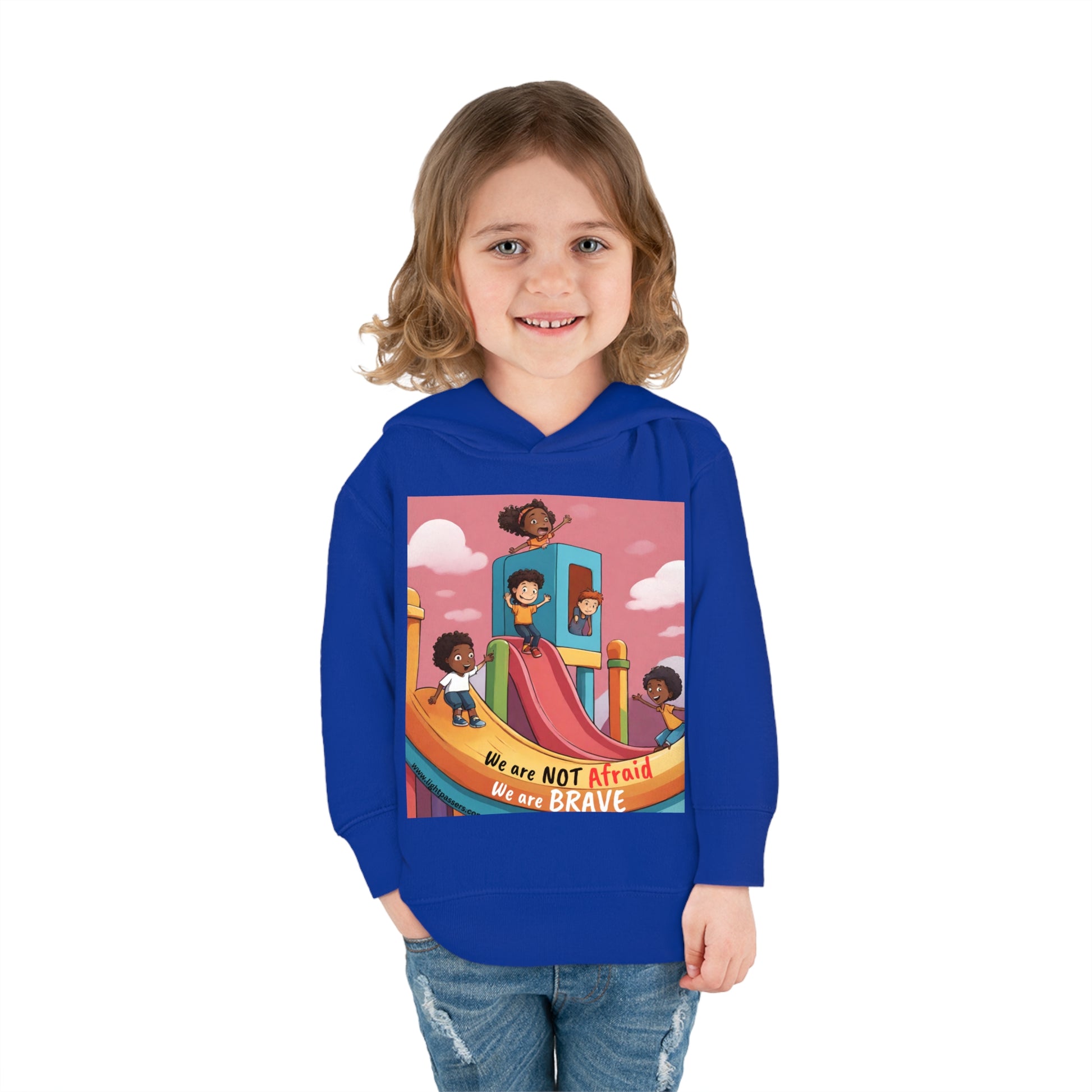 A toddler wearing a Rabbit Skins hoodie with cartoon characters, smiling at the camera. Features jersey-lined hood, side seam pockets, and durable stitching for lasting coziness.