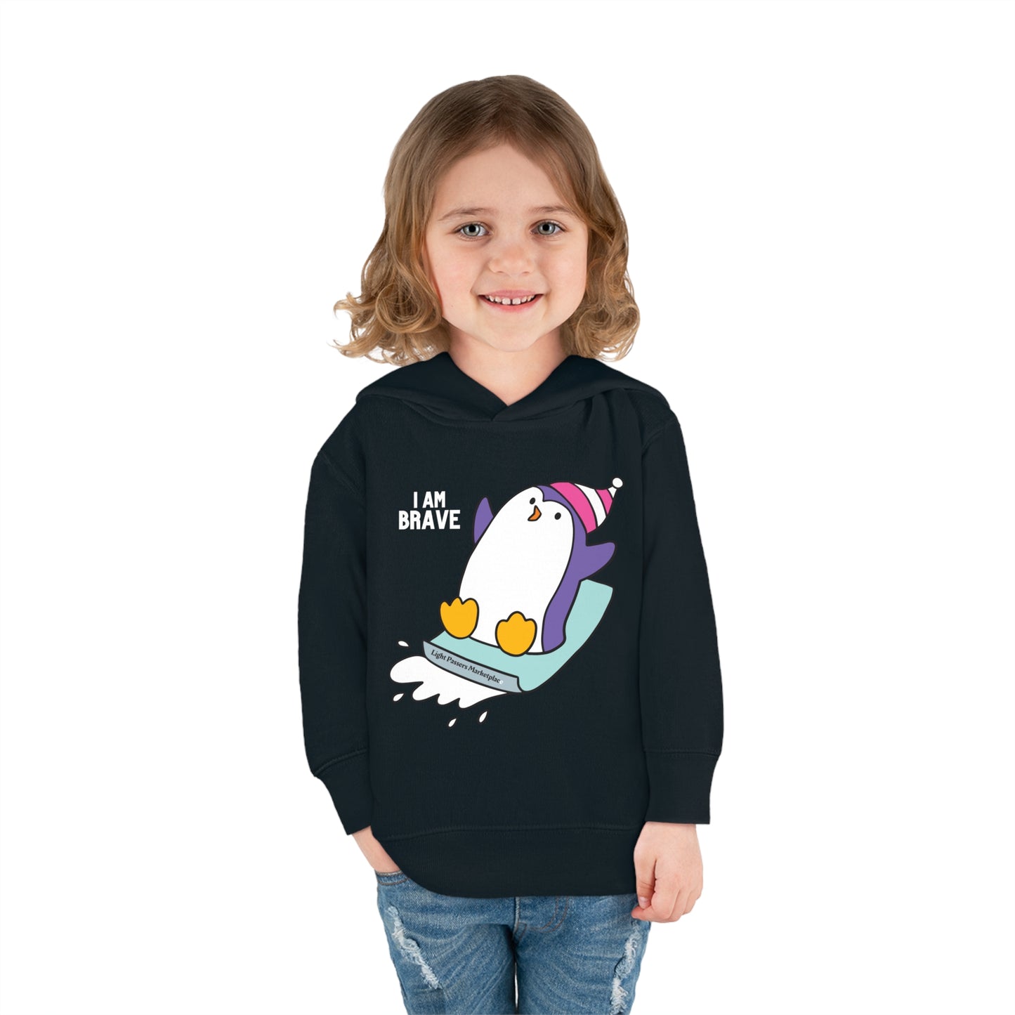 A toddler wearing a black sweatshirt with a penguin design, featuring a jersey-lined hood and side seam pockets for comfort and durability.